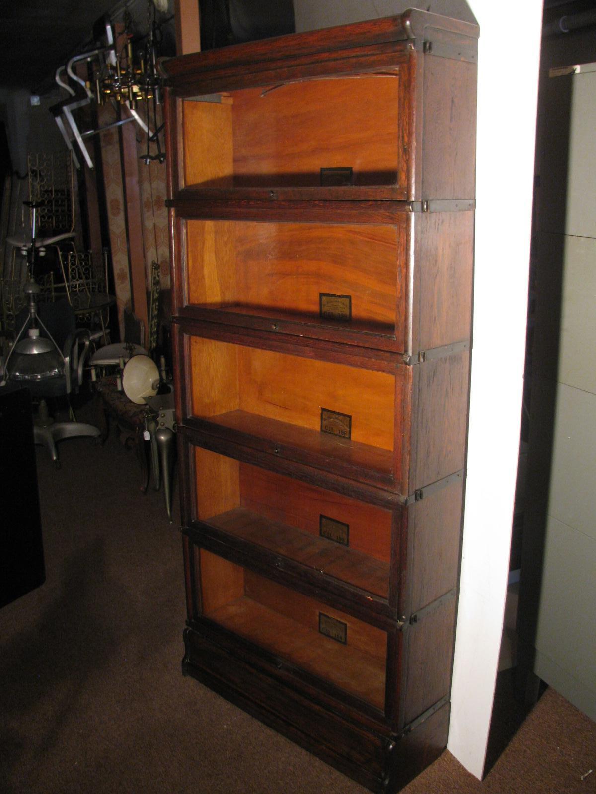Fabulous 7 piece stacking oak barrister bookcase. Five sections for storage with a top and bottom. Created by the Globe-Wernicke co. famous for these type bookcases. All doors operate freely and easily push inward for retrieval of items displayed.