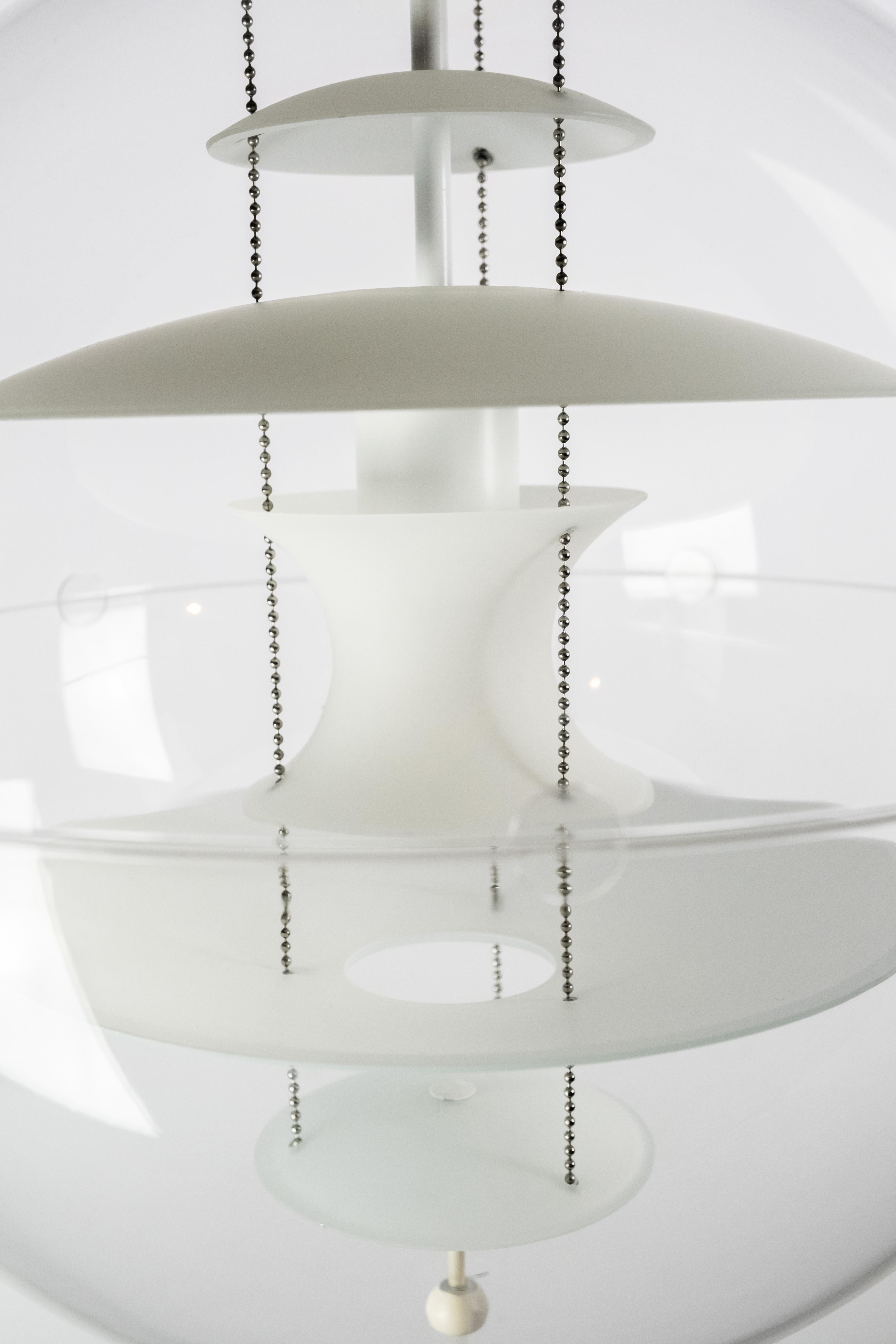 Globe designed by Verner Panton in 1969. The lamp is a transparent acrylic globe with 5 hanging reflectors in white opaline glass. Model Ø40
 