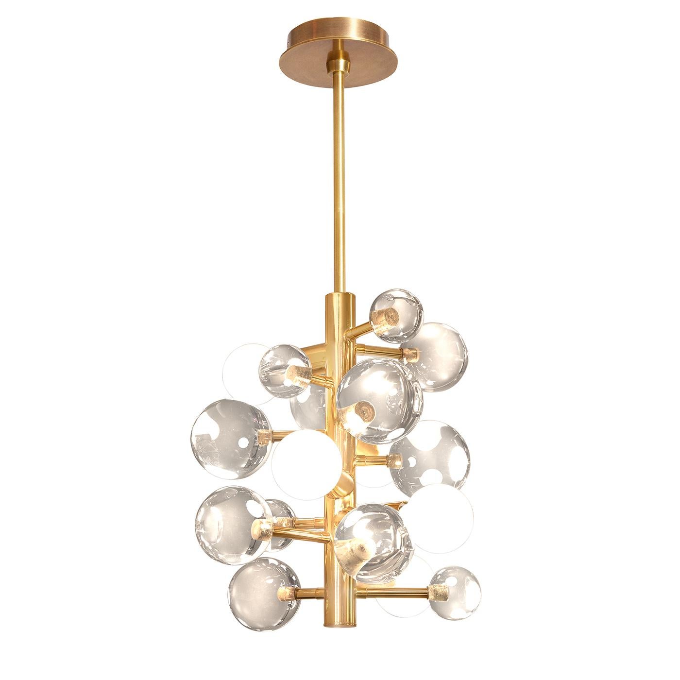 Lustrous sculpture. A constellation of Lucite spheres floats on a brass stem with five interspersed globe bulbs to create a glamorous rhythm of light. Diminutive in scale but big in style, think of our Globo five-light chandelier as jewelry for your