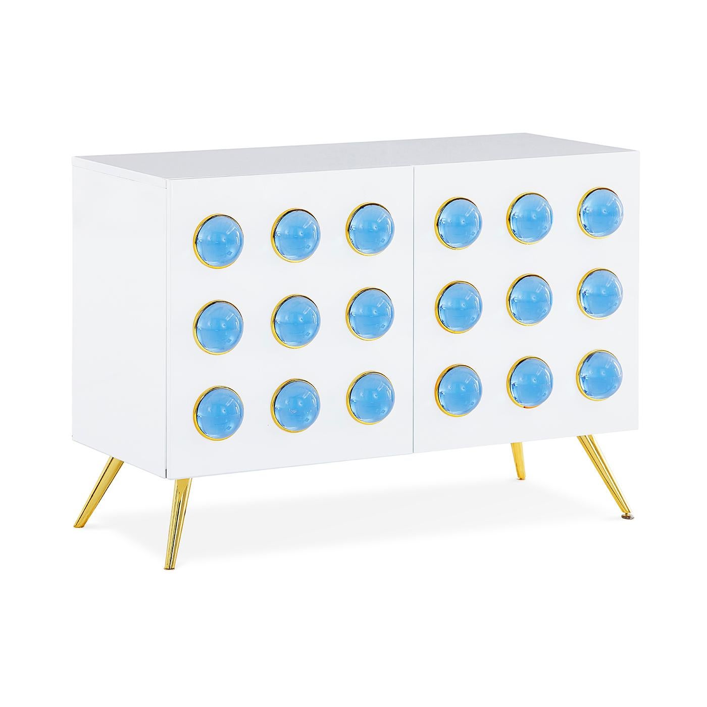 Futuristic elegance. A glossy, white lacquer cabinet featuring two front doors capped with blue solid acrylic cabochons. Tapered brass legs give it an elegant edge. Guaranteed to deliver mega glamour while you stash your stuff.

Specs:
White,