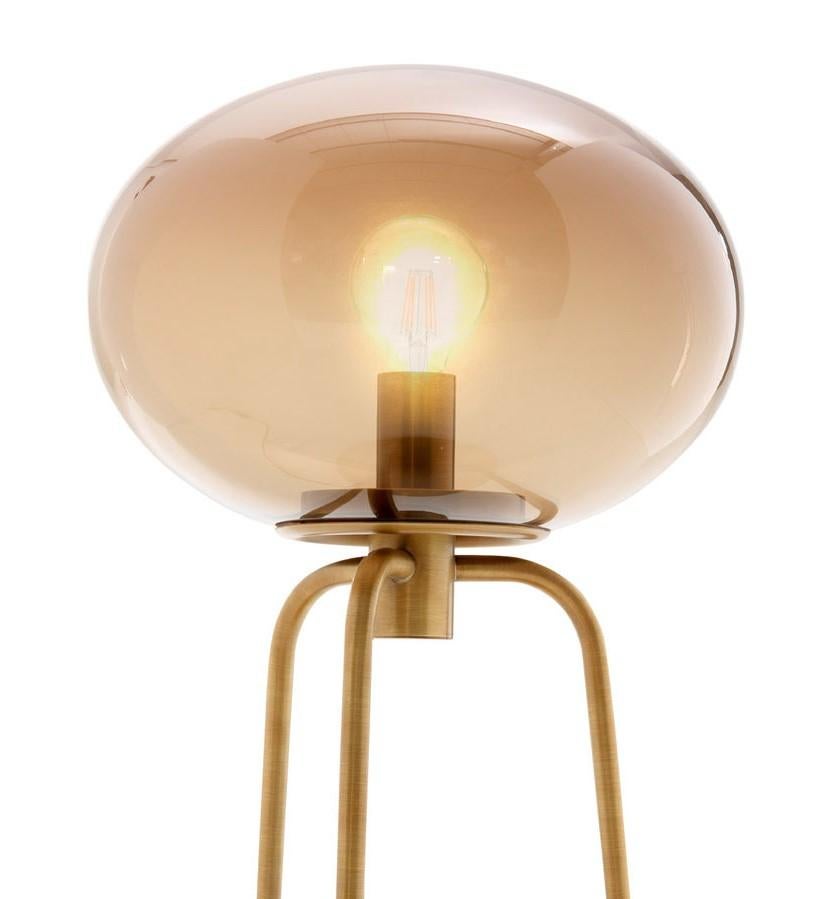 Infusing warm light on a desk in a study or nightstand in a bedroom, this table lamp will be a striking and elegant piece to showcase in any interior. The structure combines tonal colors, a timeless silhouette, and elegant finishes with the