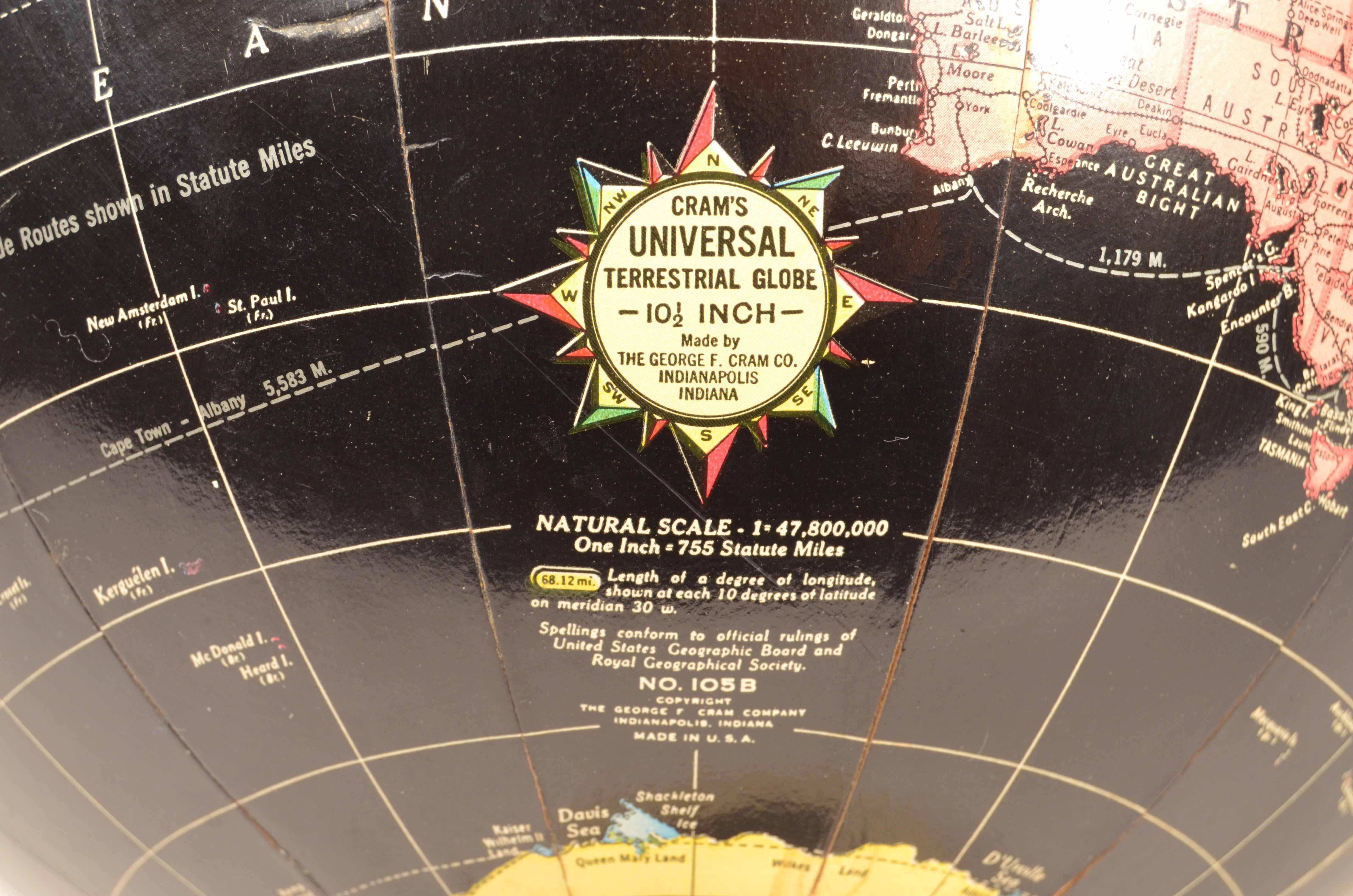 Black globe copyright The George F. Cram Company Indianapolis Indiana of the 1950s. Metal base, paper mache sphere. In addition to the very well delineated spatial map, the main trade routes of the period are depicted.  
Good  condition, a few small