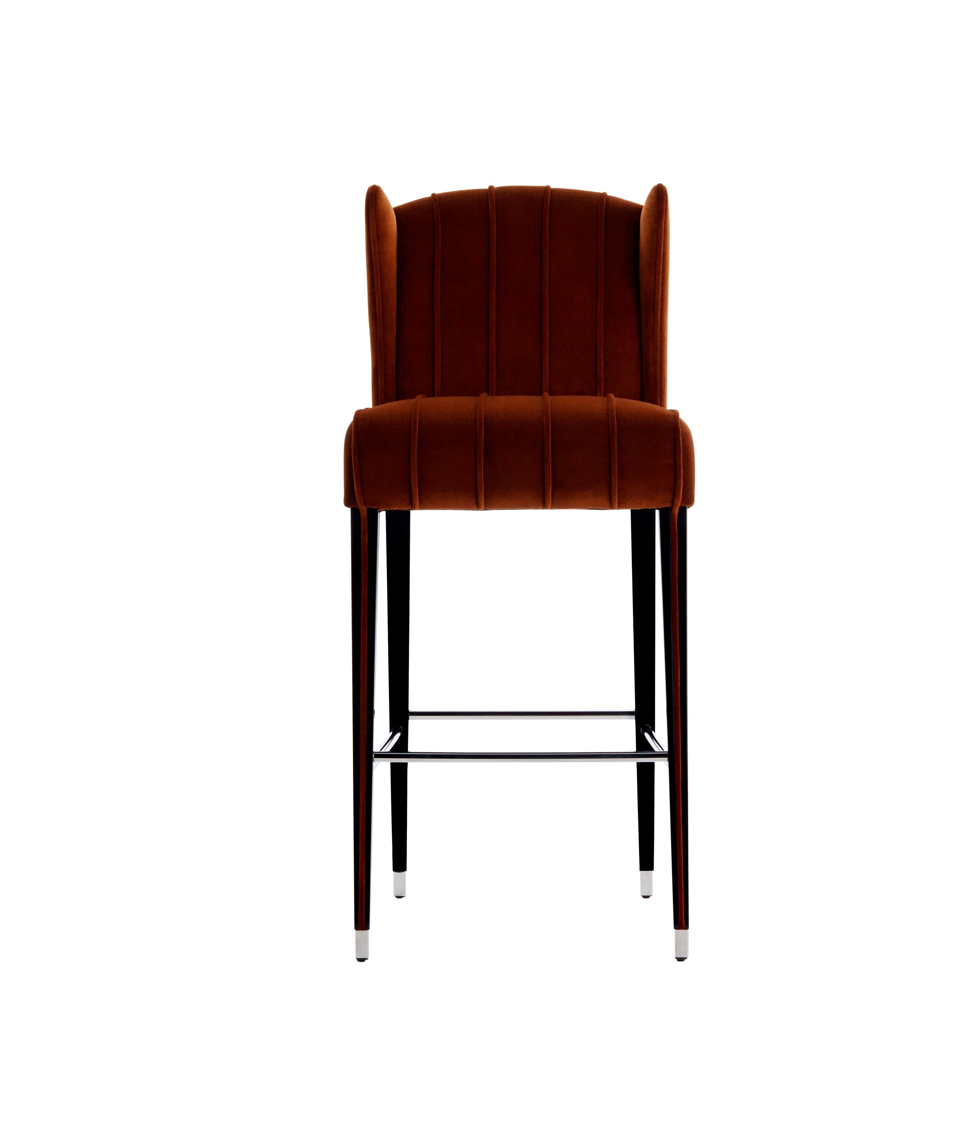 GLORIA bar stool: STOCK UNIT - Available for immediate delivery

The sophisticated bar stool GLORIA is entirely upholstered in velvet and is characterized by the piping detail runing from the backrest up to the legs, this enhances the beauty and