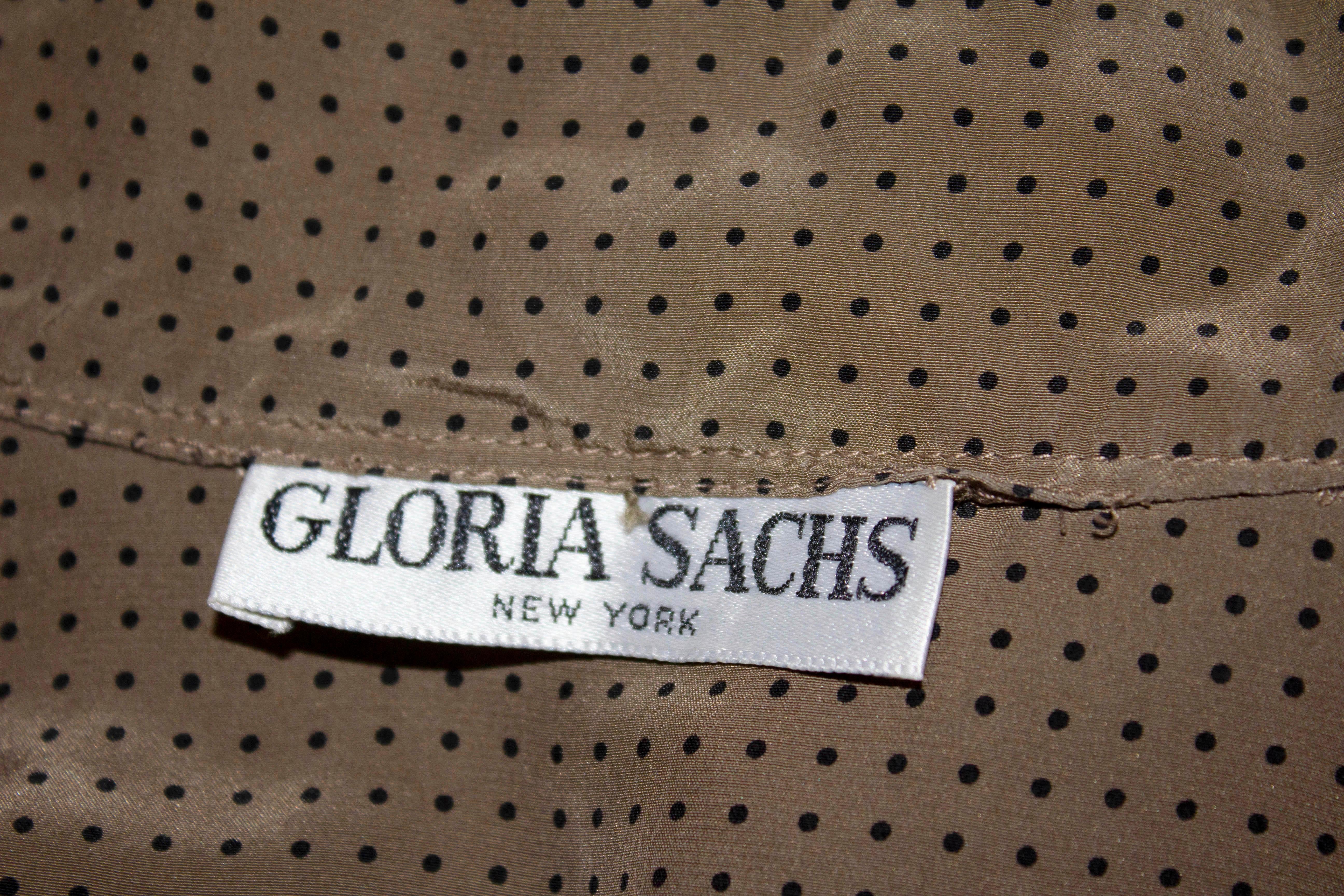A super soft vintage silk blouse by Gloria Sachs , New York, The blouse is coffee coloured with black dots , a single button cuff , front opening and attached kneck tie.
Measurements: Bust 36'', length 25''