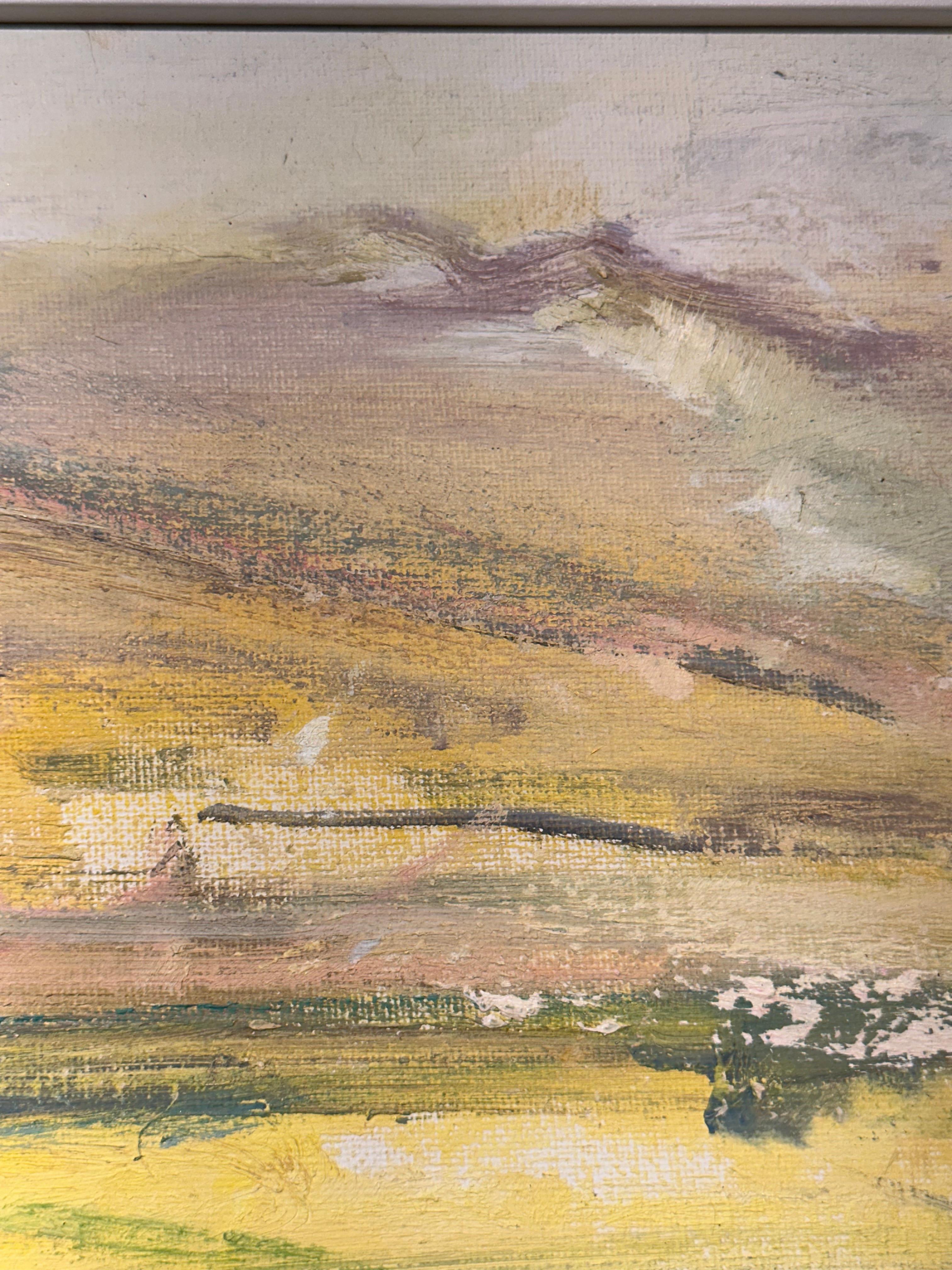 Imagine standing on a rise overlooking miles of open land. The fields before you ripple in shades of gold and amber, kissed by late afternoon light. Soft purples and dusty greens ground the foreground, while the horizon dissolves into rose-tinted