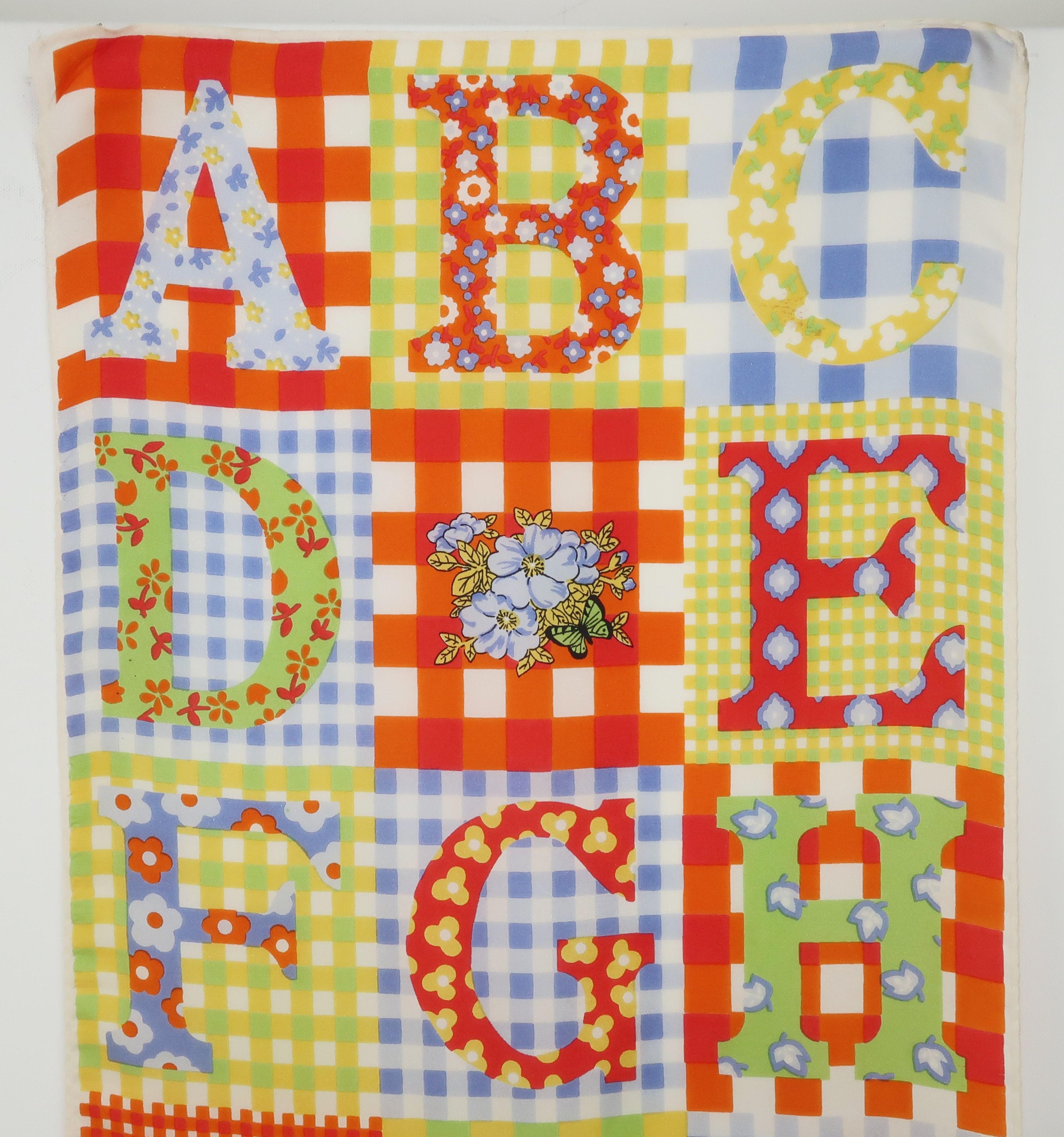 Get the 'ABC's' of style from the American fashion icon, Gloria Vanderbilt.  This long silk scarf from the 1970's depicts art work created by Ms. Vanderbilt and features a whimsical design with gingham backgrounds in shades of yellow, green, orange,