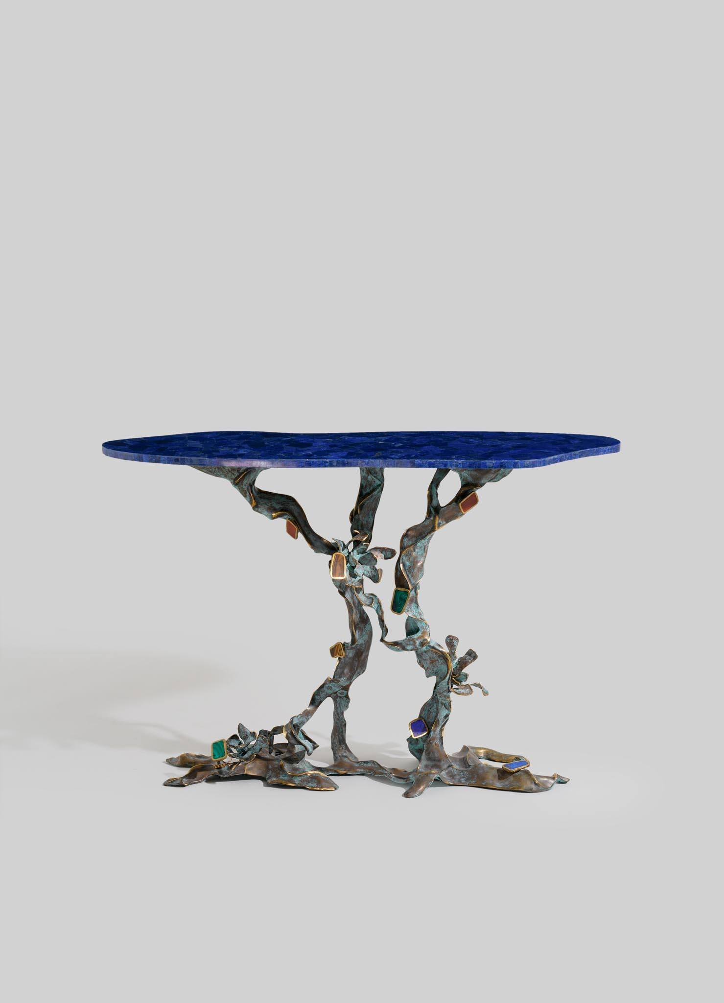 Glory Lily Console Table in Semi Precious Stones & Brass, Viya by Vikram Goyal

The Glory Lily flower dances in paradox, embodying breathtaking beauty and potent power. A striking climber, it isn’t your typical delicate flower, holding medicinal