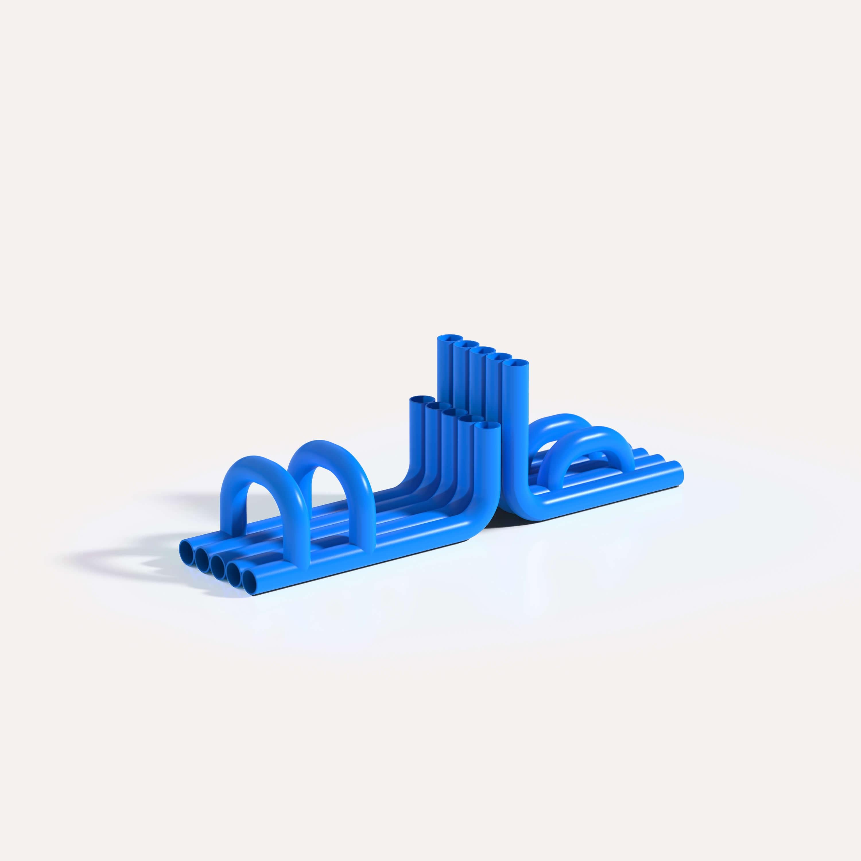 Glossy Blue Tube Bookends by Maha Alavi Studio
Dimensions: W 29 x D 13 x H 17 cm
Materials: Stainless Steel, Metal. 

Maha Alavi is a Tokyo-based Canadian industrial designer. Her practice aims to explore context through connection and creation,