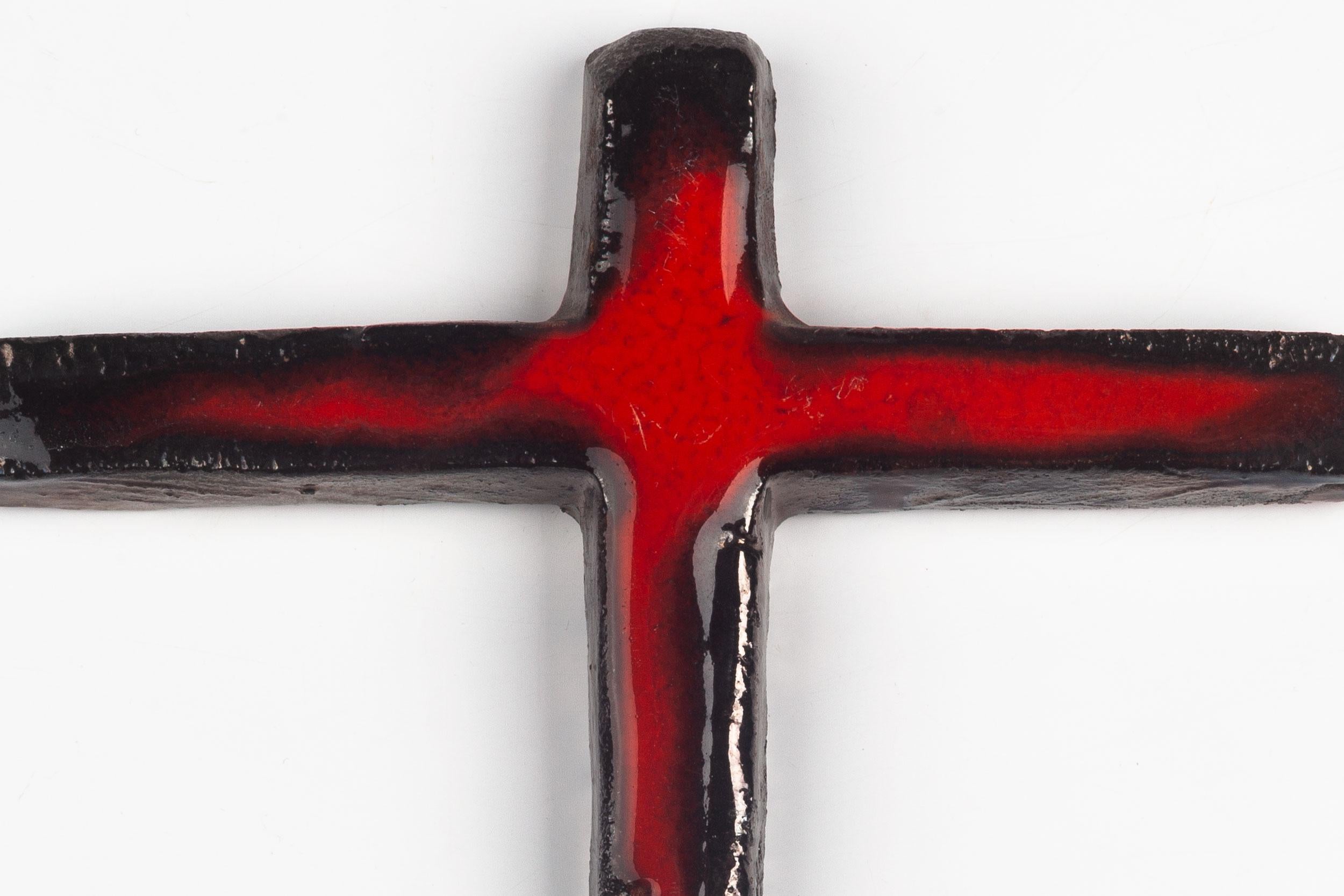 Mid-century European crucifix in ceramic with high gloss glaze and hand-painted in bright red and black. A one-of-a-kind, handcrafted piece that is part of a large collection of crosses made by artisan potters from the 1950s to 1970s. A unique
