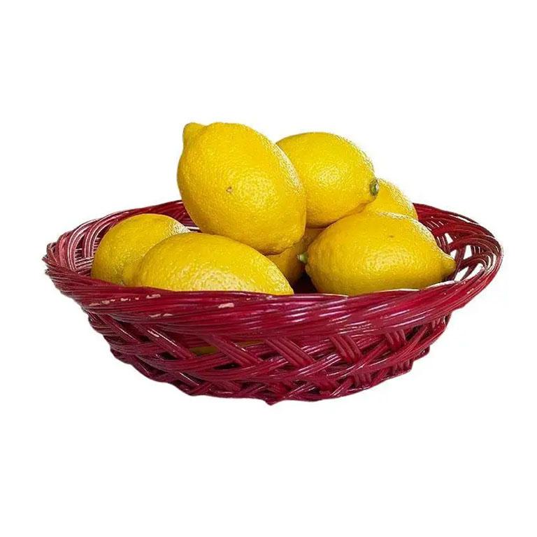 A woven wicker basket painted in glossy red paint. This piece would be fabulous to serve bread or fruits, or as a decorative dish on a night table or dresser. 

Dimensions:
10