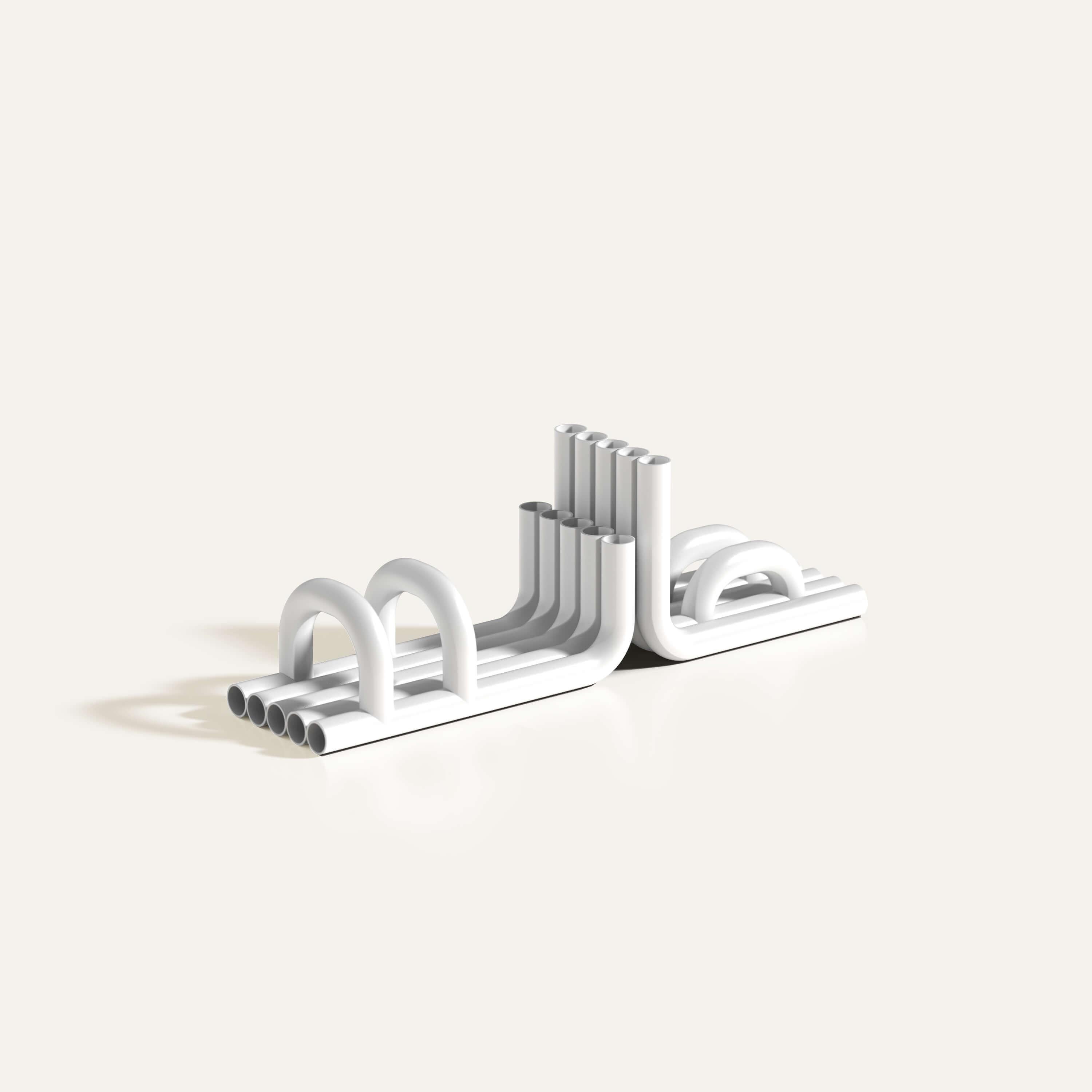 Glossy White Tube Bookends by Maha Alavi Studio
Dimensions: W 29 x D 13 x H 17 cm
Materials: Stainless Steel, Metal. 

Maha Alavi is a Tokyo-based Canadian industrial designer. Her practice aims to explore context through connection and creation,