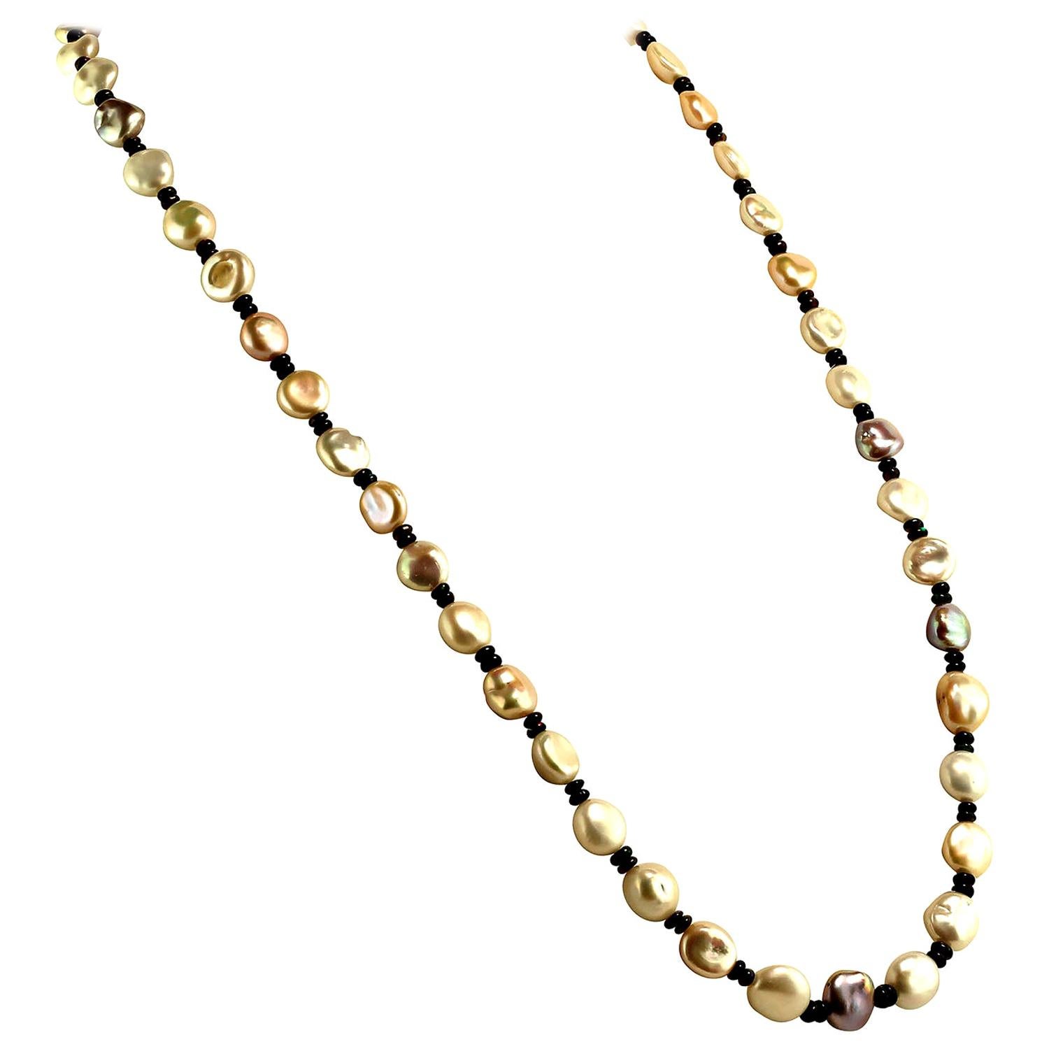 28 Inch necklace of glowing, iridescent second harvest Freshwater Pearls.  These gorgeous natural colored Pearls are accented with Black Opal rondelles which produce lovely flashes of red, green, and blue. At 28 inches this  necklace can ONLY be