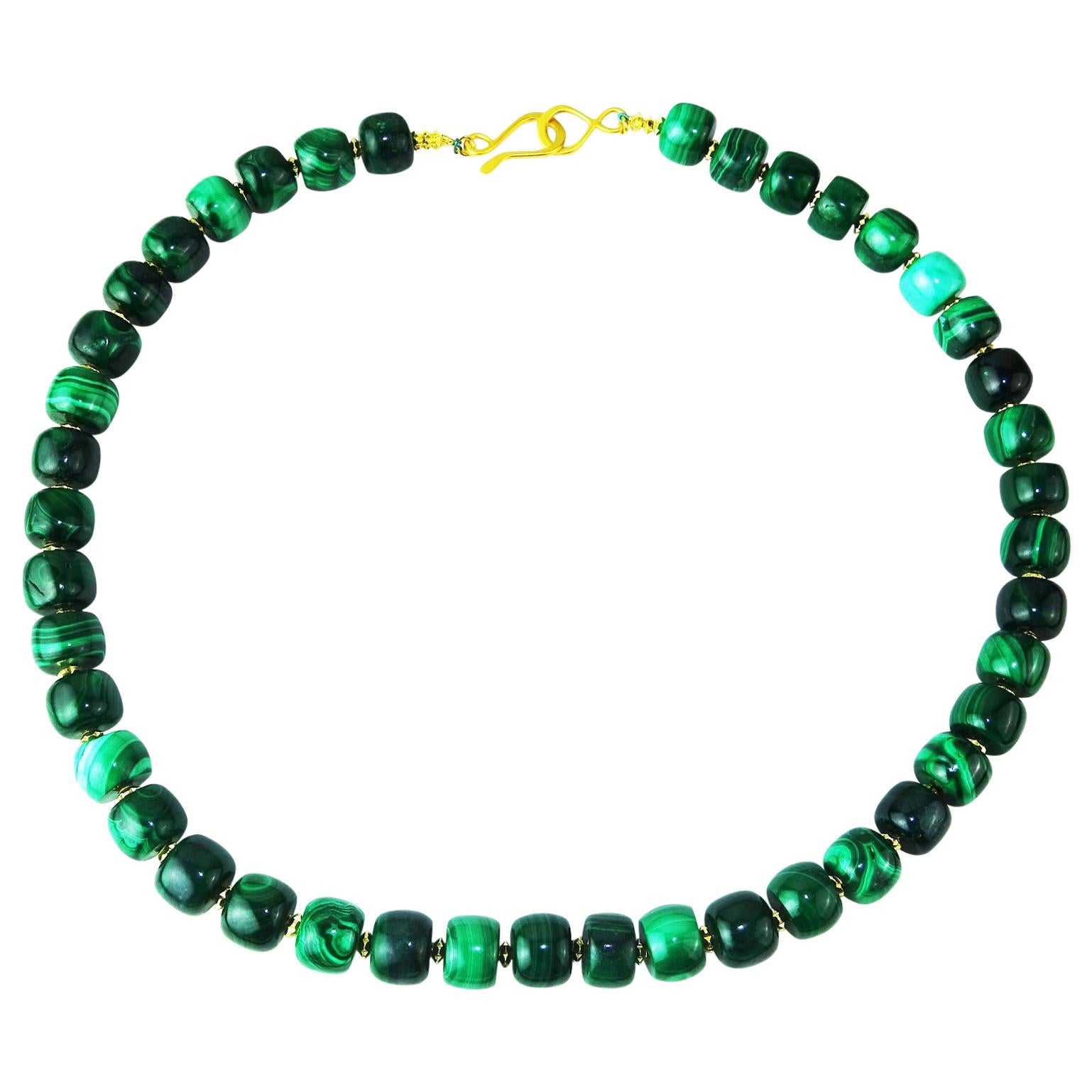Feel elegant in green. 22 Inches of Beautifully polished barrel shaped Malachite Necklace. The gem barrel shape, a nice design change, is enhanced with gold tone fluted accents. The gold vermeil hook and figure eight clasp enriches the entire