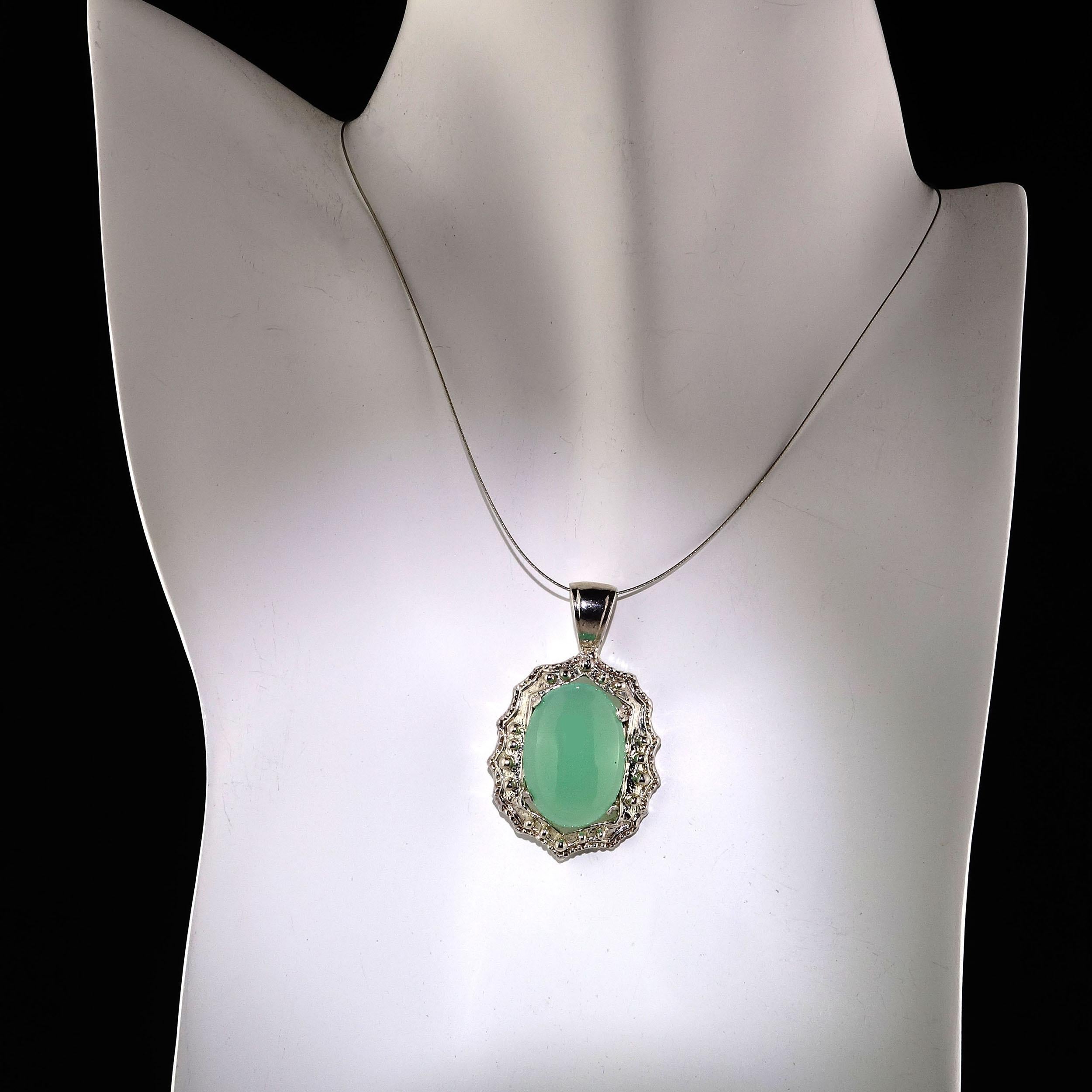 Unique warm, glowing Chrysophrase in fancy detailed Sterling Silver pendant. This lovely Chrysophrase is 20 x 15 MM, and weighs 11.90 carats. Wear this elegant pendant with all your Spring fashions. The soft green is complementary to everything in