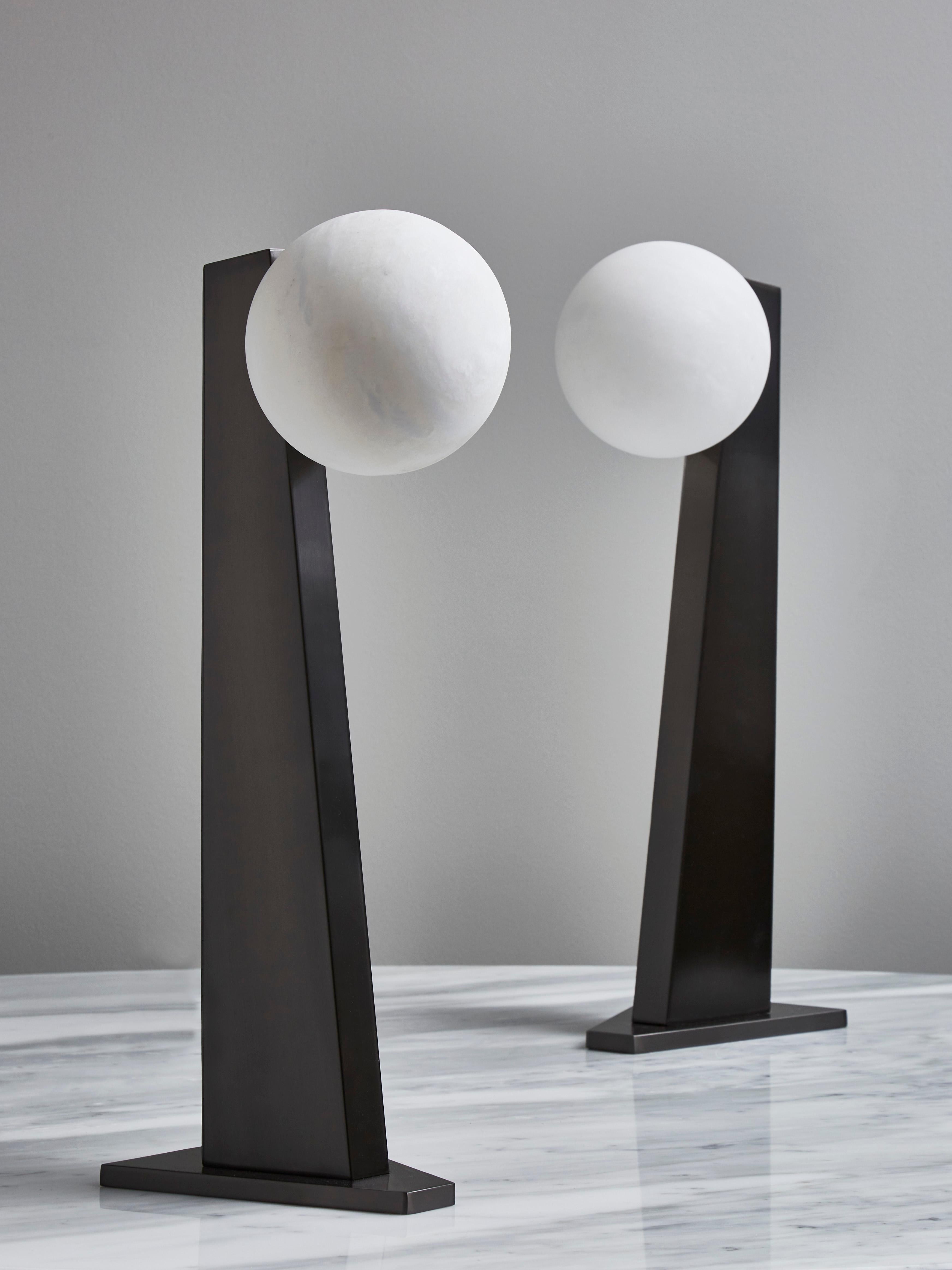 Table lamp version of our popular floor lamp, asymmetrical brass foot in black nickel satin finish holding a single alabaster globe.

Designed by Glustin Luminaires

Price displayed per table lamp.