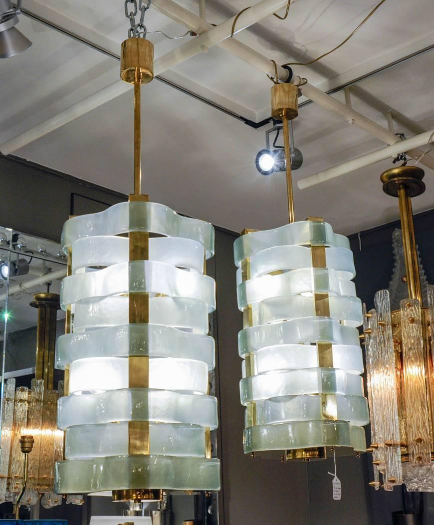 Brass lanterns with Murano glass ribbons stacked.
 