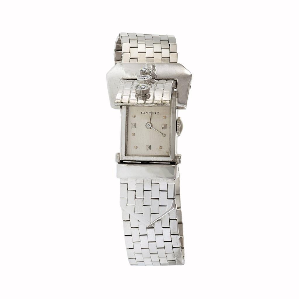 The vintage Glycine bracelet watch timepiece from the 1930s, crafted in 14Kt white gold, epitomizes timeless elegance. Featuring a manual wind movement, it boasts a silver dial exuding vintage charm. The standout feature of this watch is its diamond