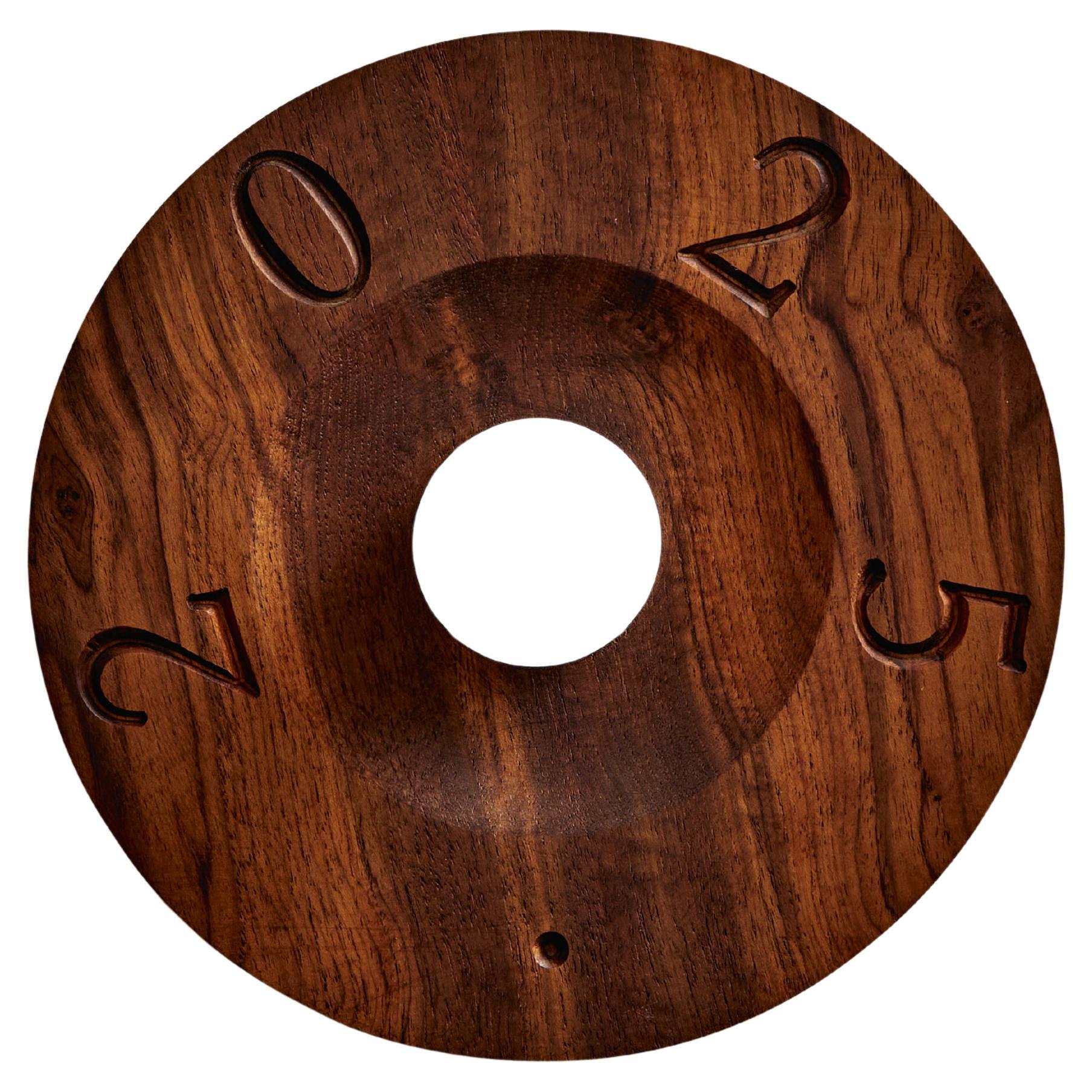 L'applique Glyph parla per schemi e simboli. Scolpita in teak di recupero con finitura oliata, la sua geometria è antica e moderna allo stesso tempo. La superficie circolare rivela linee e forme che si intersecano, celebrando il linguaggio