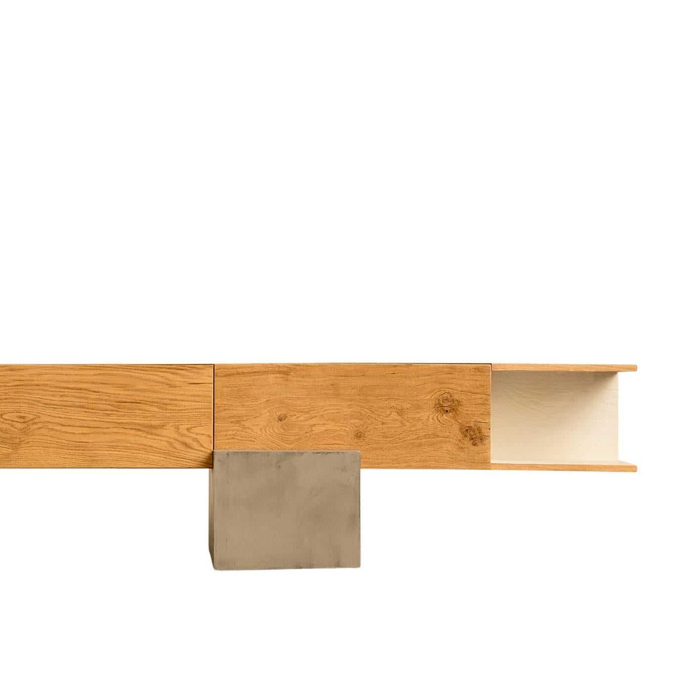 This well crafted oak beam storage unit by Giacomo Moor balances on an off centre concrete support. The cabinet has three closed compartments. Two doors fold downward, and one folds upward, and an additional storage shelf has a white varnished