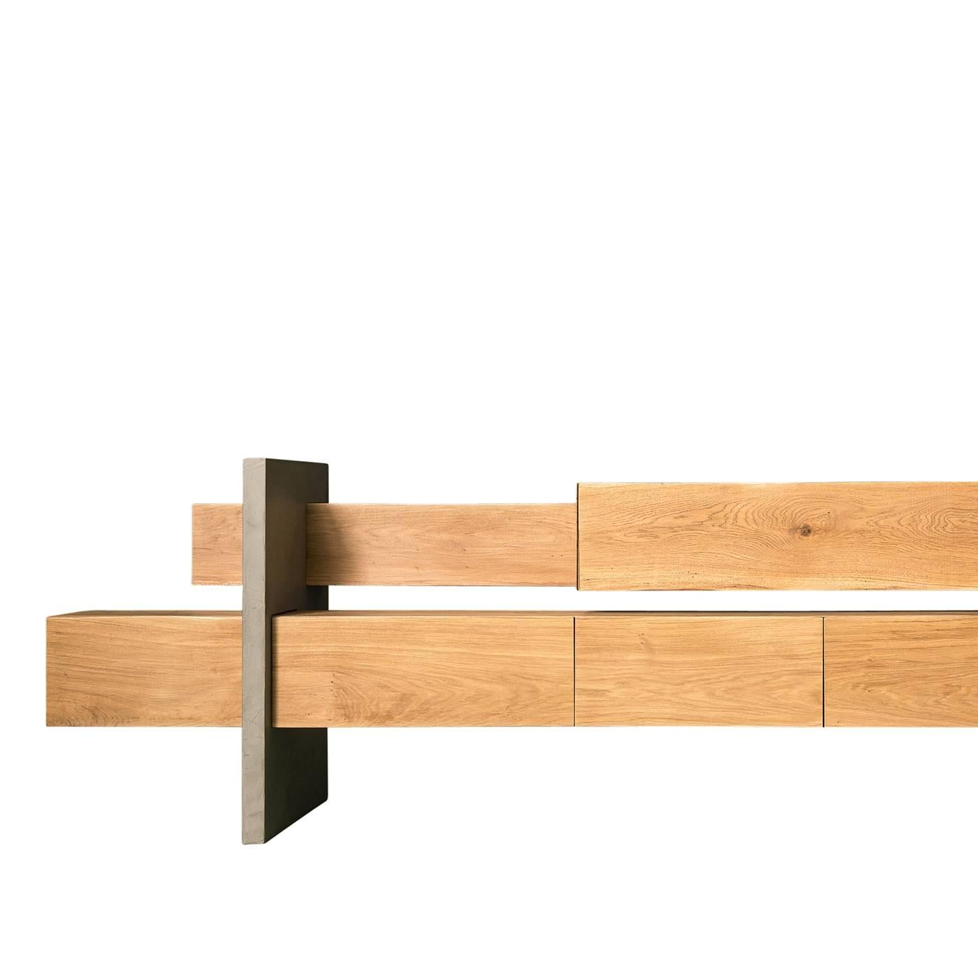 Within this oak and concrete sideboard by Giacomo Moor are six unevenly arranged storage compartments. In the lower beam there are two swinging doors, a double depth drawer, and a drawer and a white varnished compartment. In the top beam, there are