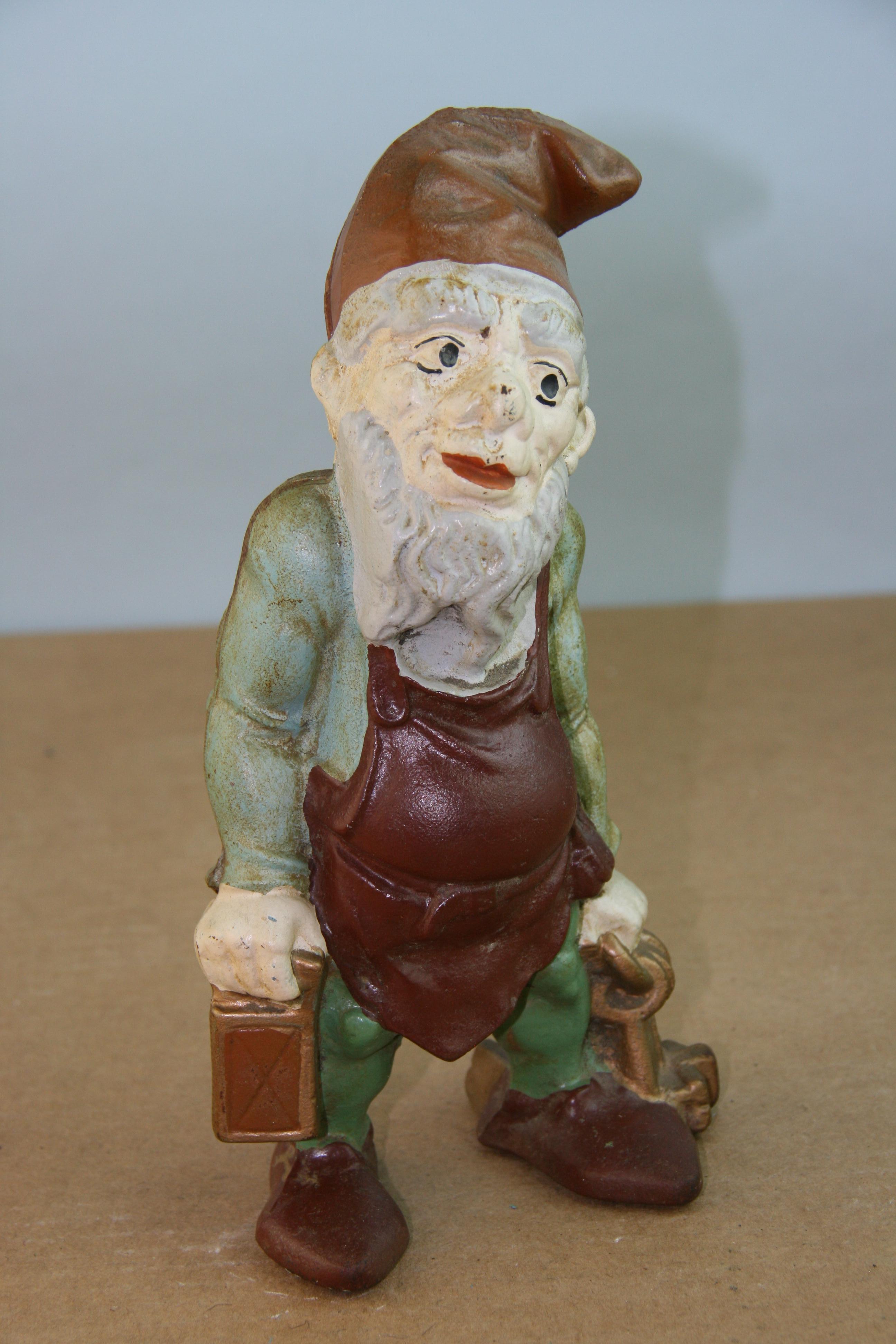 Gnome hand cast and painted American antique garden sculpture and coin bank/doorstop
In great condition considering its age.