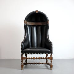 Goalkeeper's chair with turned wood frame and black leather upholstery