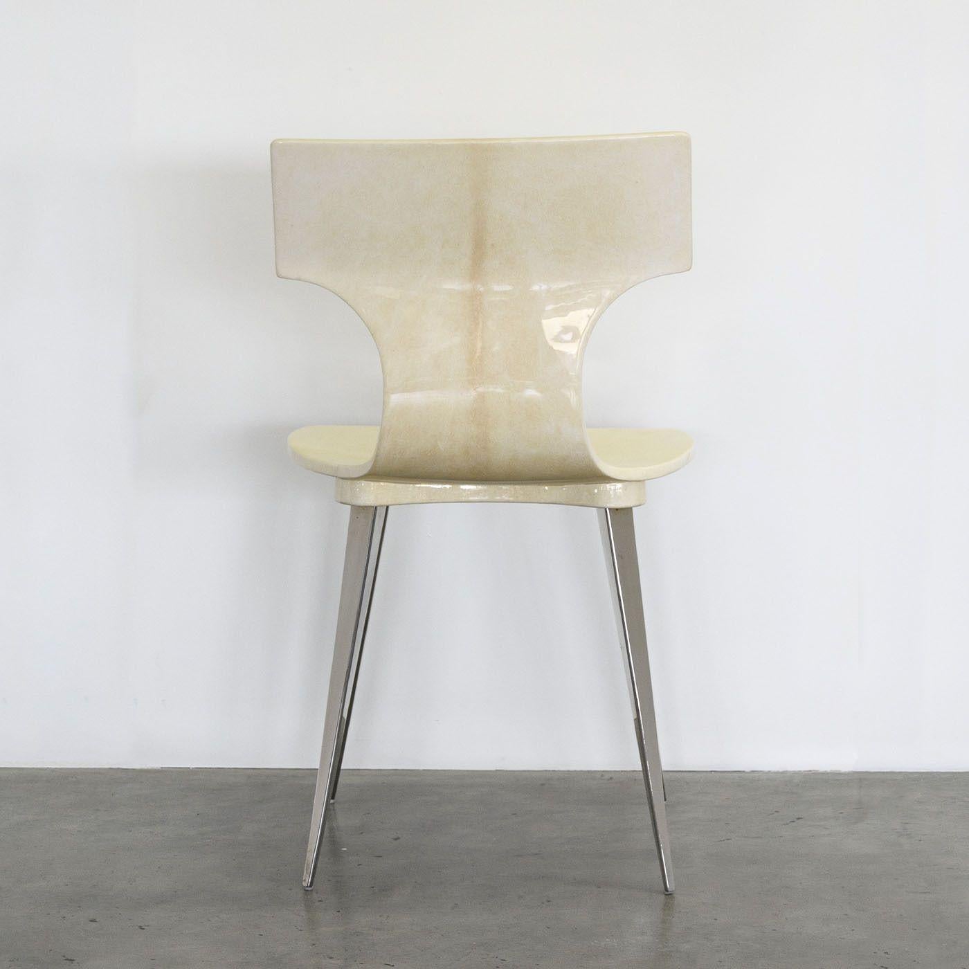 Dynamic and precious, this chair boasts a sturdy shaped shell with an ergonomic design promising long-lasting comfort. Its outstanding trait is the prized natural goatskin parchment fully enveloping its shell, finalized by a high gloss finish