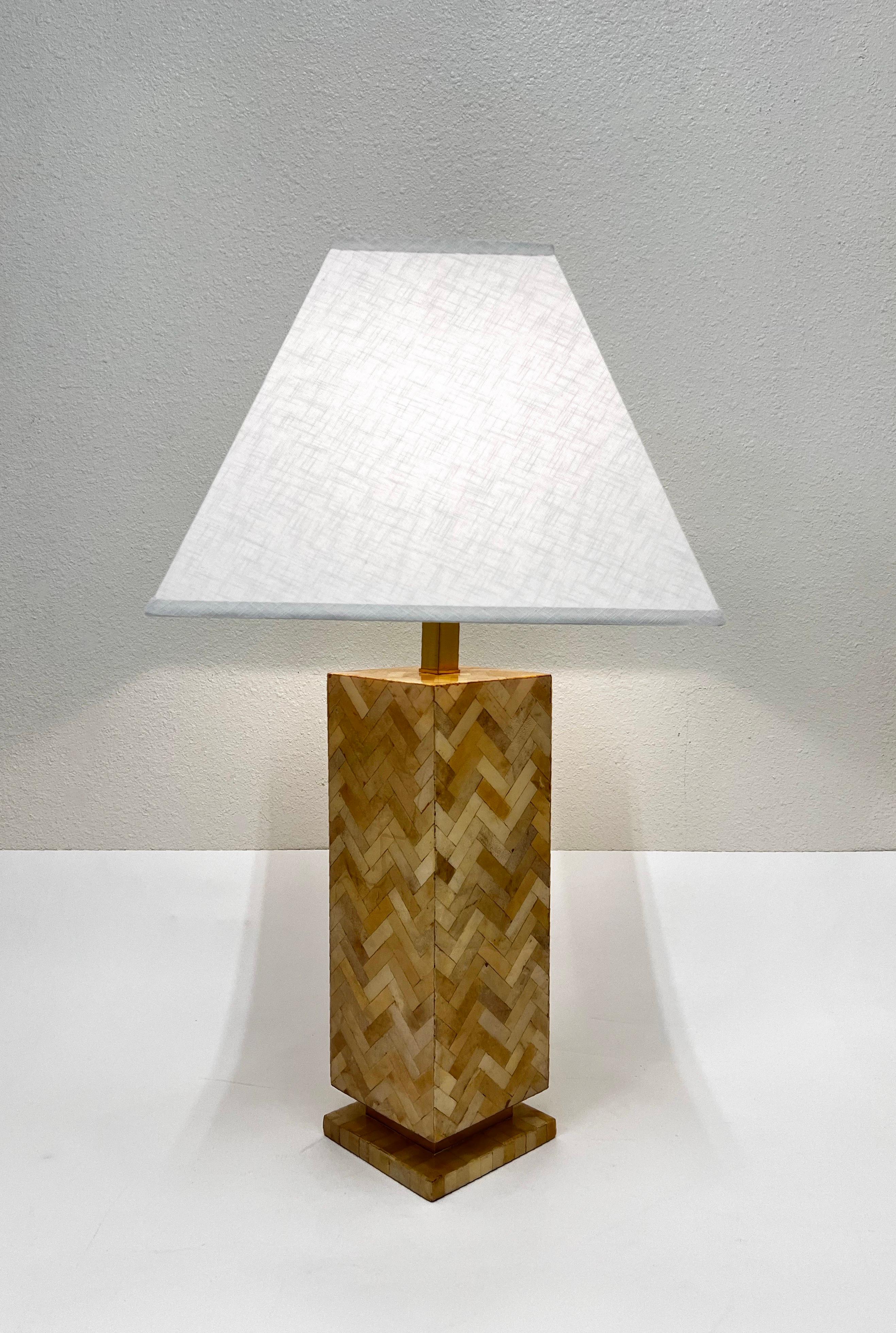 1970’s Colombian goatskin parchment and polish brass table lamp by Enrique Garcel. 
Newly rewired with all new hardware and new linen shade. 
Constructed of wood covered with goatskin pieces arranged in a chevron pattern and then covered with a