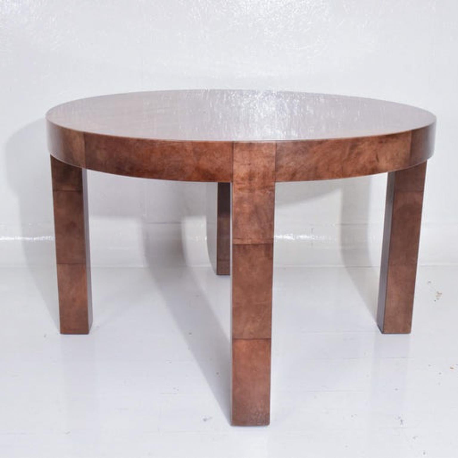 Sensational lacquered goatskin wrapped dining table in caramel brown. Sheer Elegance.
Intimate dining, circular form on thick legs. No extension leaves.
Unmarked. Attributed to designs of Aldo Tura Italy 1960s and style of Karl Springer.
Original