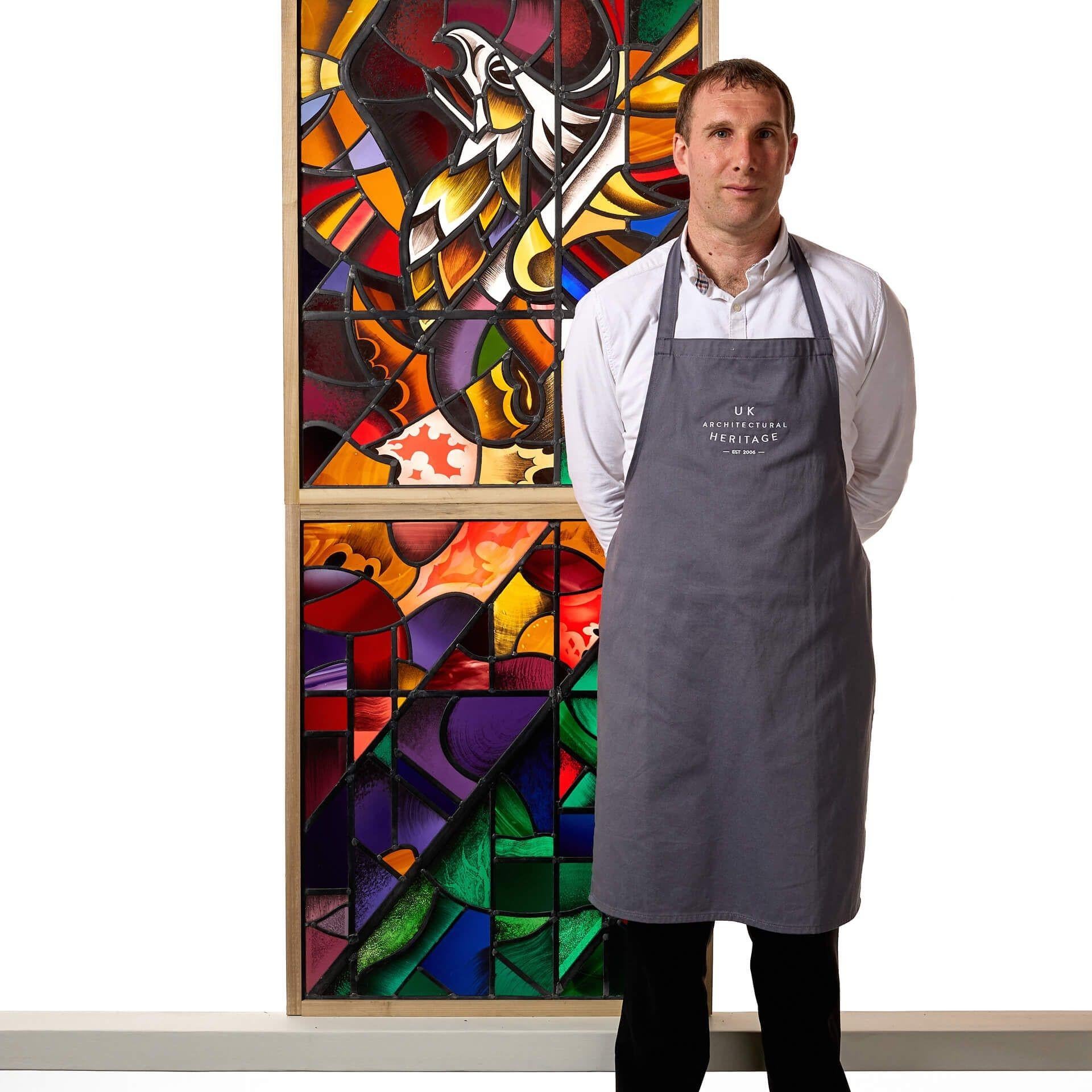 An impressive Goddard & Gibbs stained glass panel of a stylised phoenix on a geometric background.

Each feature of the mythical bird is expertly crafted in a variety of vibrant colours and patterns to create an eye-catching stylised abstract