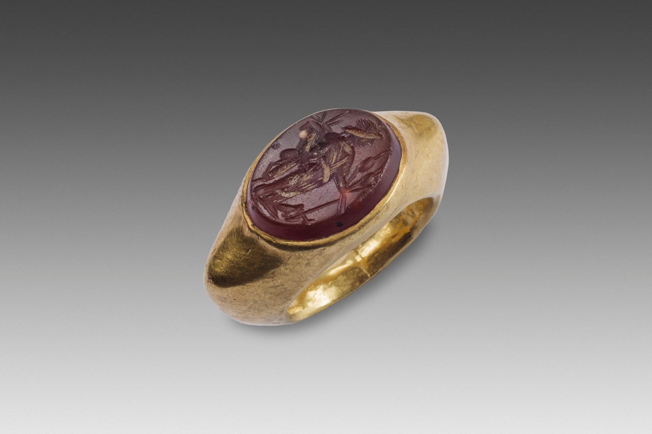 Ring with the Goddess Fortuna 
Roman art, beginning of the imperial era (1st-2nd century AD)
Carnelian
Measure: D 2.35 cm
 
 The ring, almost circular in shape at the bottom, has an angular shoulder; it was carefully hammered into a thin sheet of