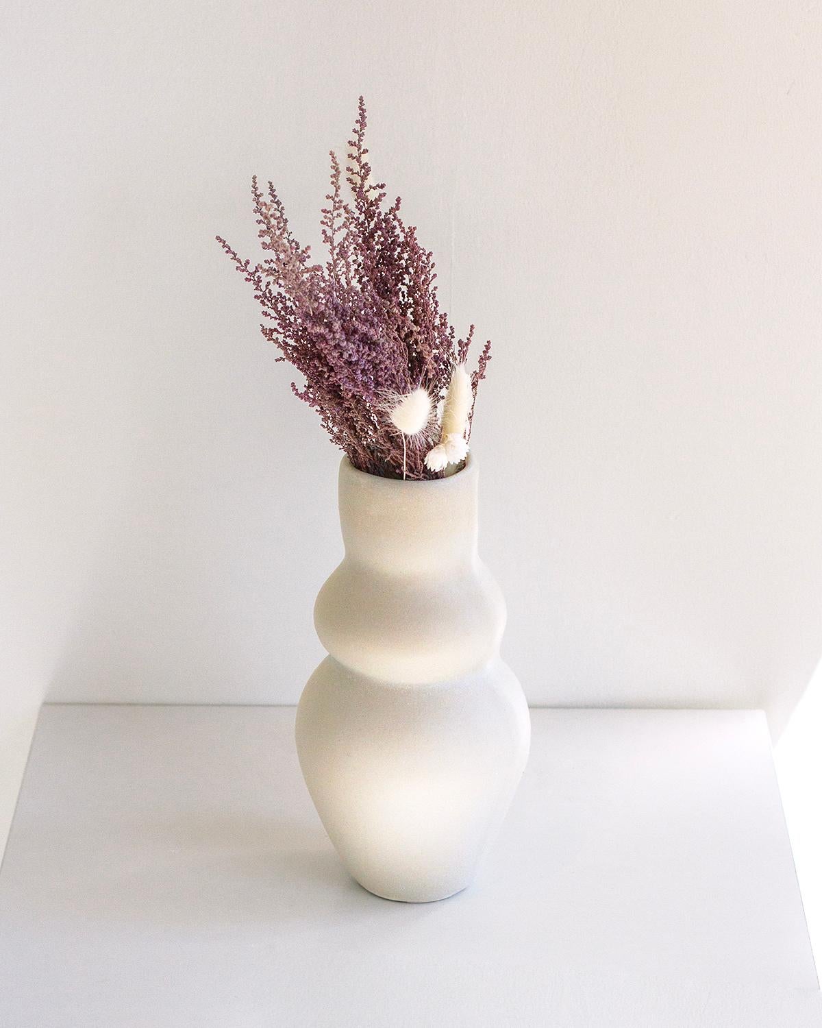 This handmade Goddess Clay Vase is a perfect addition to any home décor. It is crafted from white clay with a minimalist design that makes it both unique and modern. Its delicate texture is perfect for arranging flowers and branches and it makes an