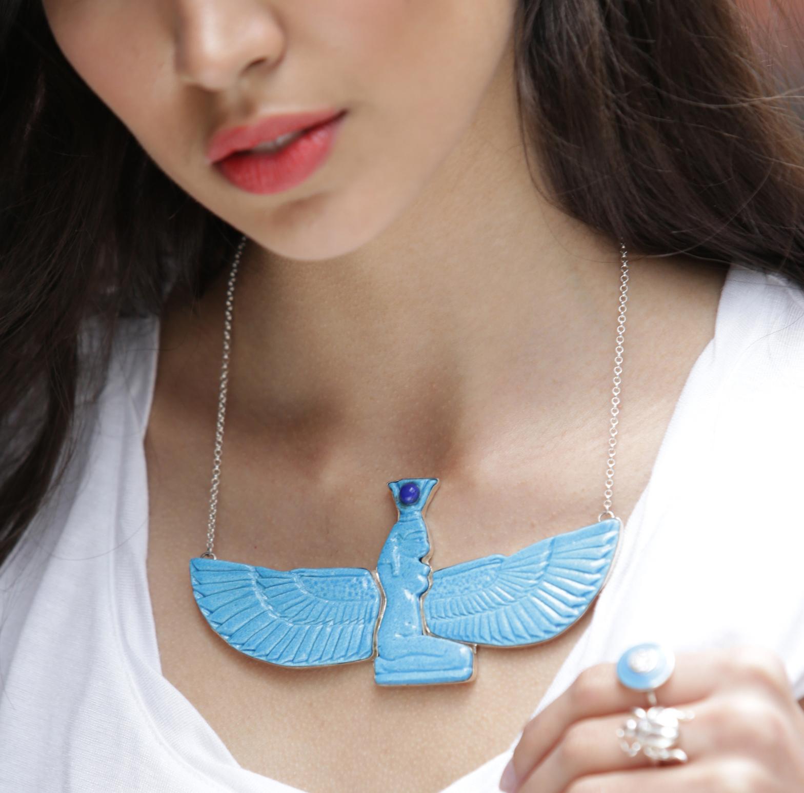This show-stopping one of a kind piece features the Goddess Isis who spreads her wings proudly. Hand made in Egyptian Faience, it is as if you rated your own tomb.

Worshiped in Ancient Egypt for being the ideal mother and wife alongside being the