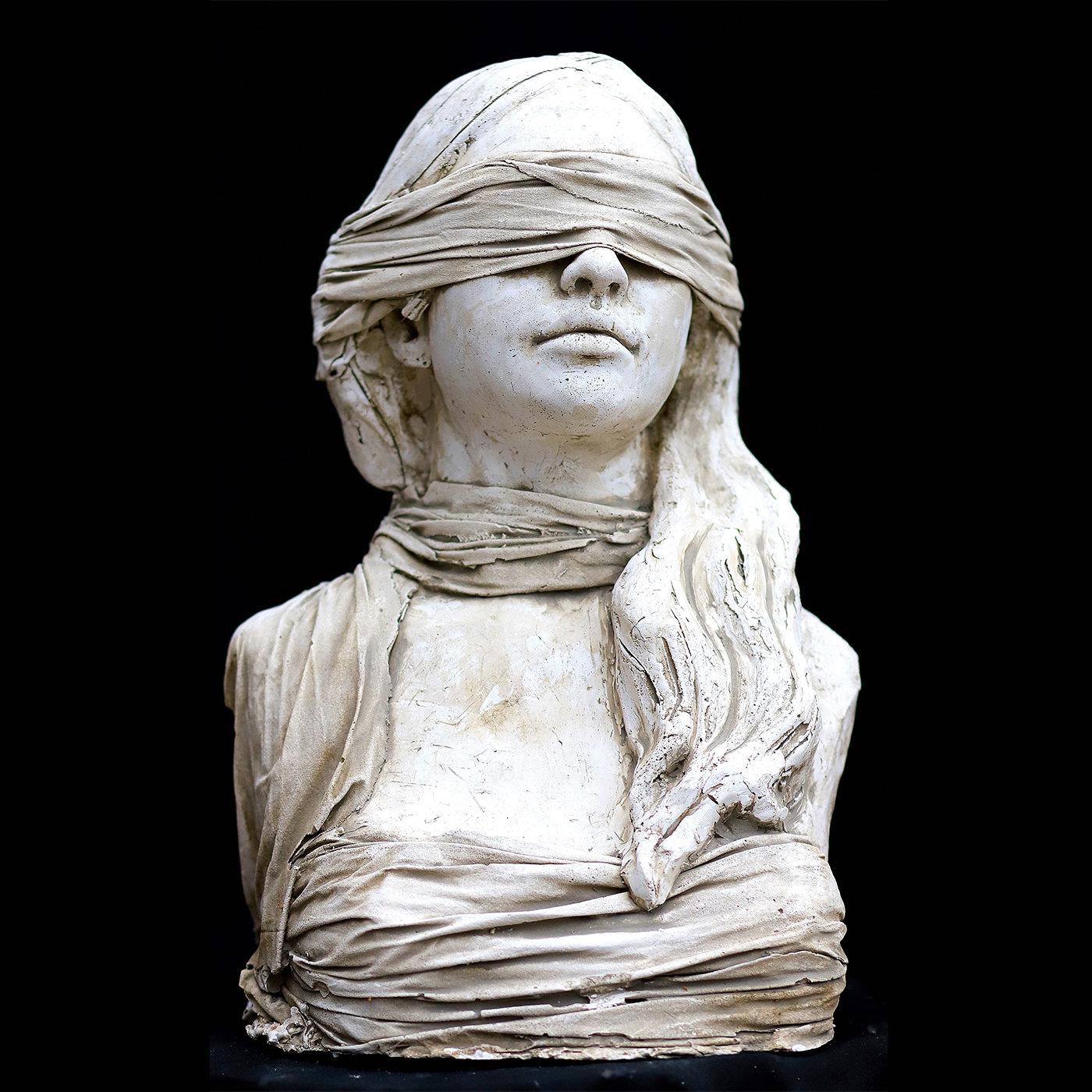 A splendid decorative object that will embellish any home or office, this magnificent work of art is handcrafted of plaster by sculptor Raffaello Romanelli in 2020. It depicts the bust of a blindfolded woman representing the Roman goddess Fortuna, a