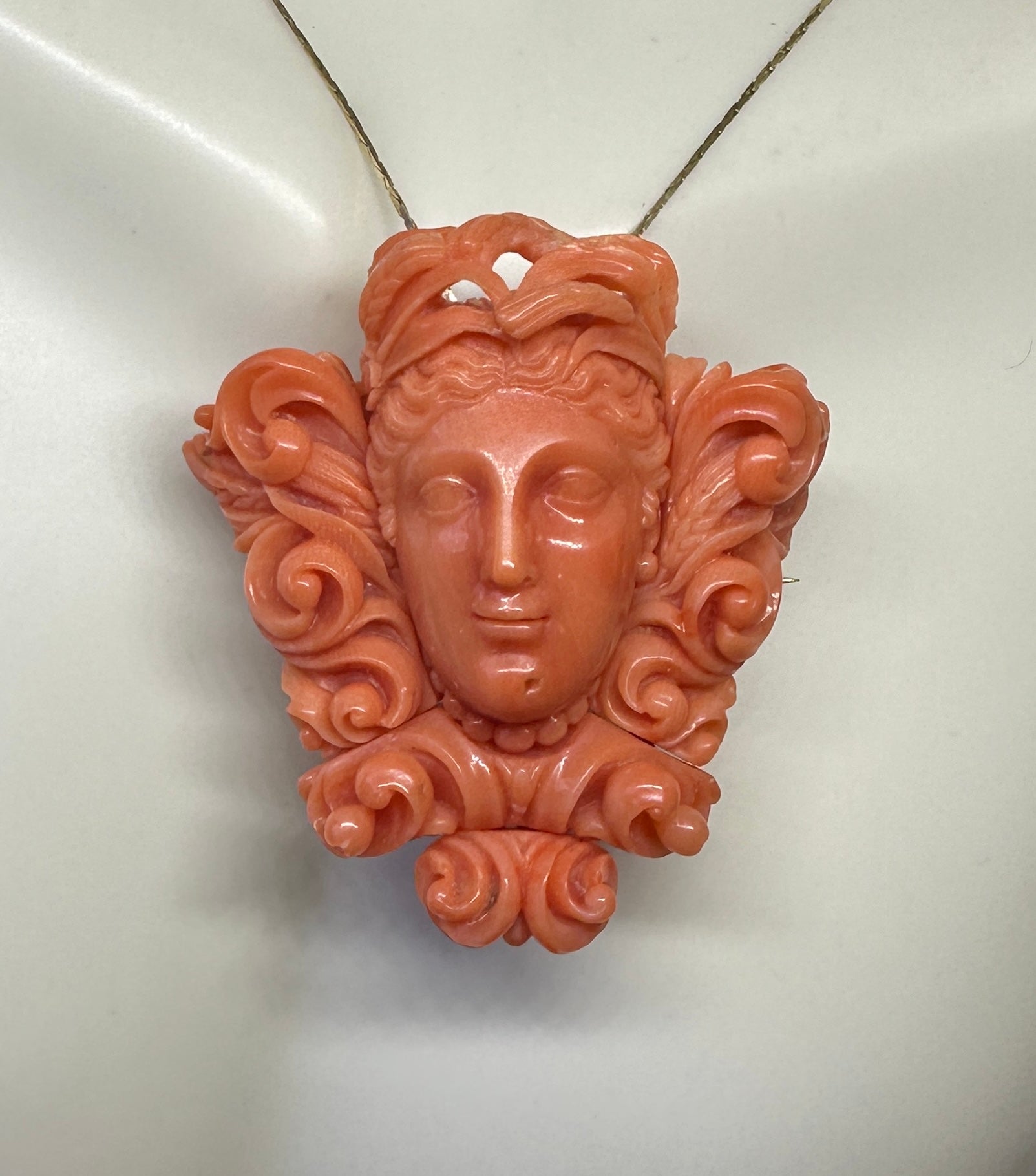 This is a Museum Quality Antique Victorian Etruscan Revival Carved Coral Pendant Necklace or Brooch depicting a Goddess or Maiden.  The Coral Goddess is set in 10-14 Karat Gold.  The pendant is a masterpiece of the period.  The brooch portion is