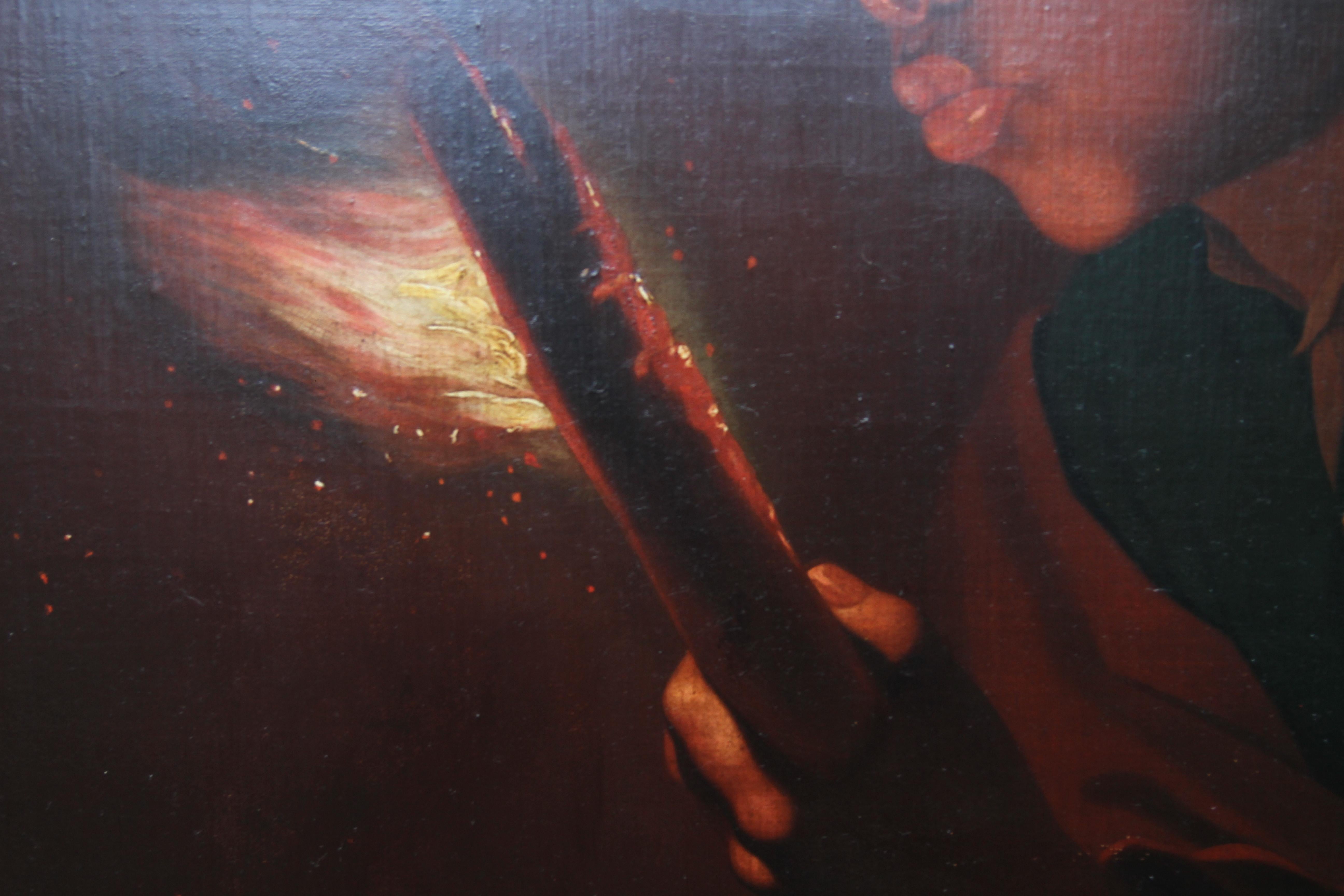 a boy blowing on an ember to light a candle