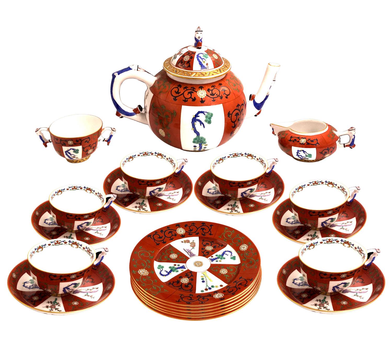Godollo tea set in Herend Porcelaine for 6 persons. Japanese Kakiemon inspired hand-painted porcelain decorated with alternate white and red bands adorned with floral motifs and stylized trees in green, blue and red. On handles, decoration of Asian