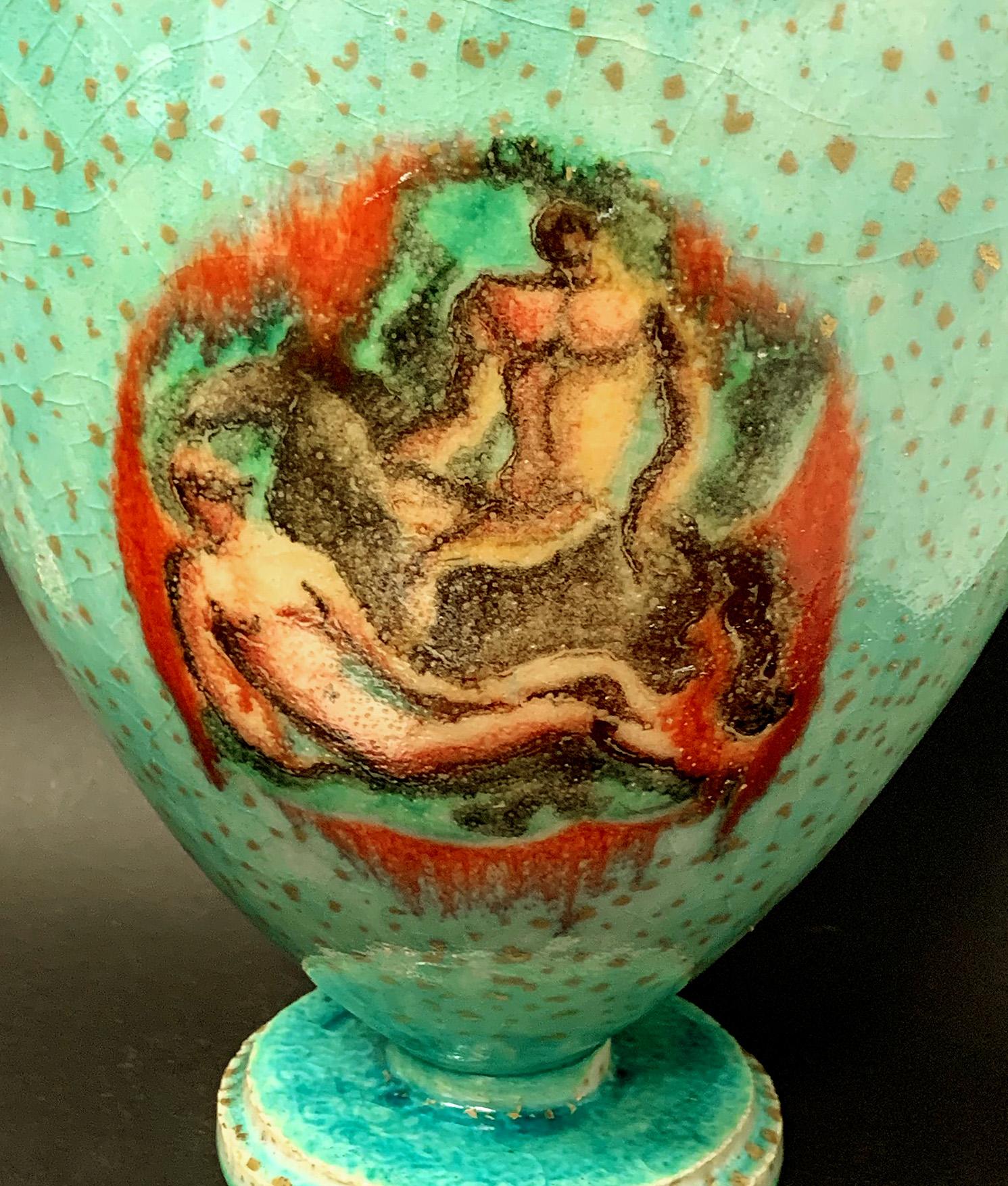 No doubt by the great French ceramic master, Jean Mayodon, this brilliantly glazed vase depicts nude gods and goddesses, accompanied by horses, presented in fluid-edged cartouches on a ground of sea green. The two scenes with nude figures are