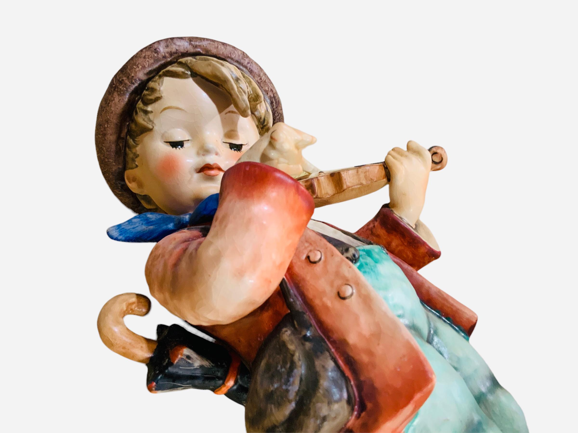 This is a Hummel porcelain figurine boy. It’s named “The Fiddler”. Its mark is TMK5 (1970’s). The inscription M.I. Hummel is in the back of the figurine. The trademark of Goebel company is below the base with the year 1972 inscribed.