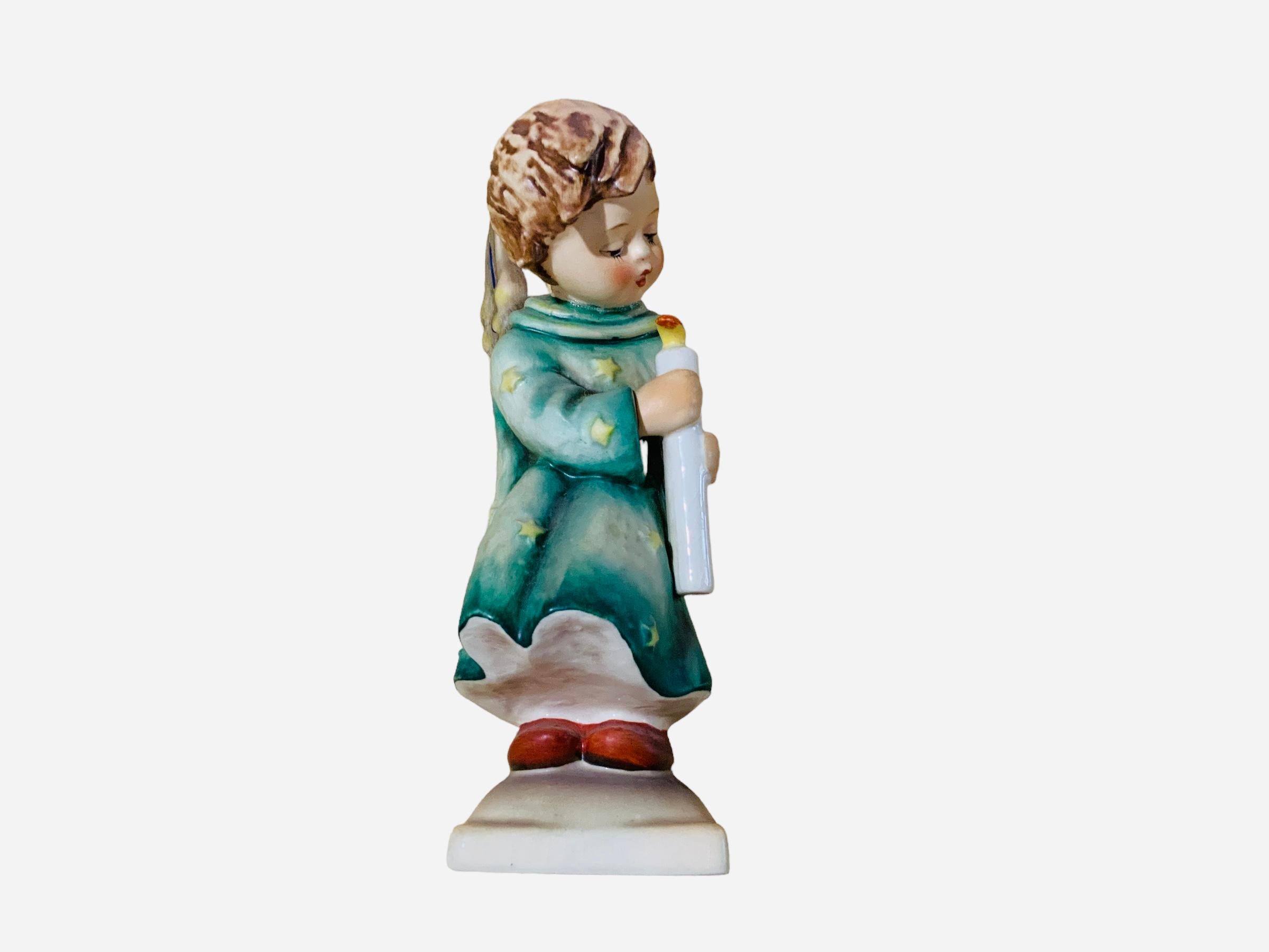 This is a Hummel porcelain figurine of an angel. It’s named “Heavenly Angel”. Its mark is TMK5 (1970’s). The inscription M.I. Hummel is in the back of the figurine. The trademark of Goebel company is below the base with the #27 inscribed.