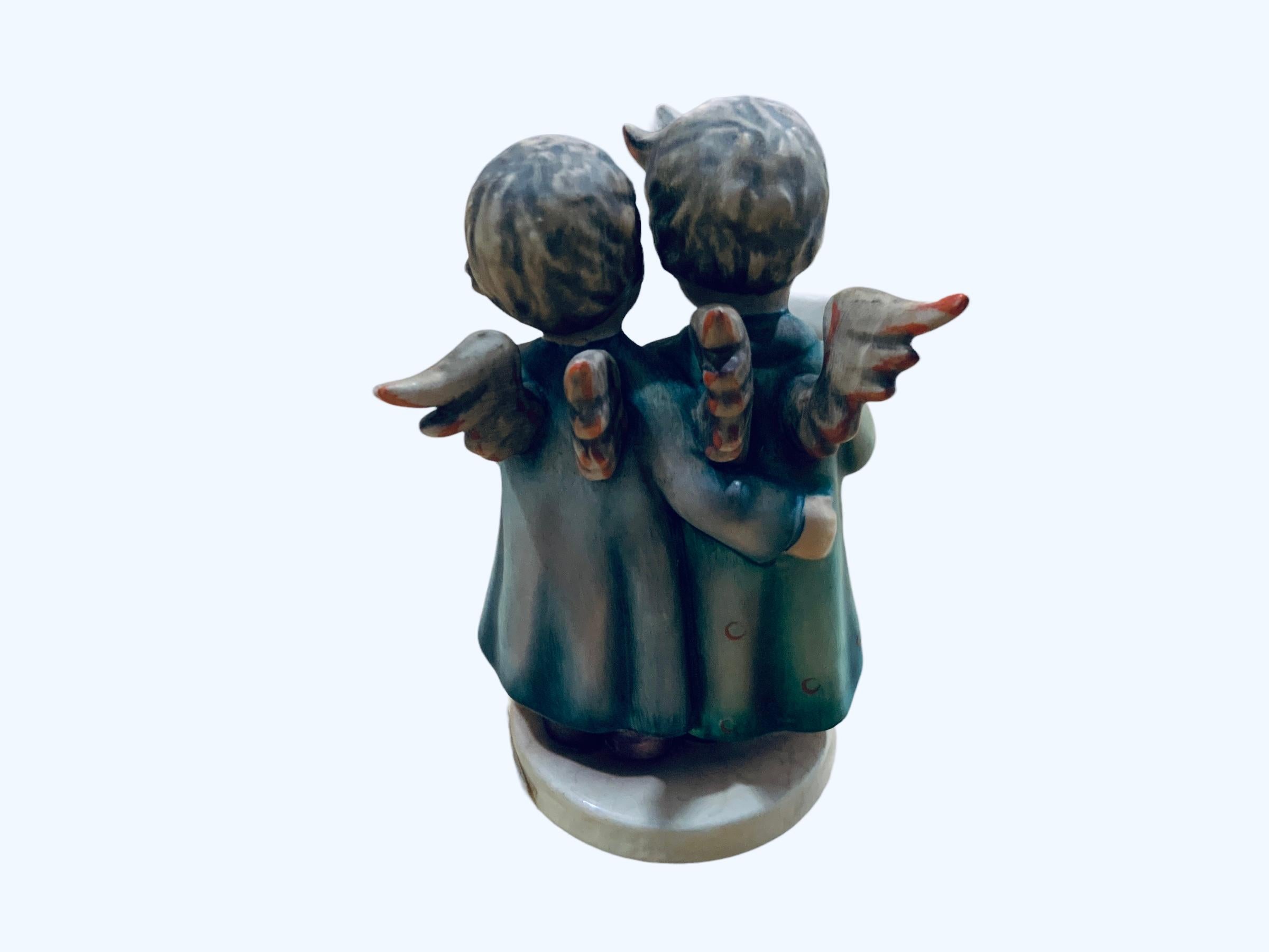This is a Hummel porcelain group figurines of angels. It’s named “Angel Duet”. Its mark is TMK5 (1970s). The trademark of Goebel company is below the base with the # 261 inscribed.