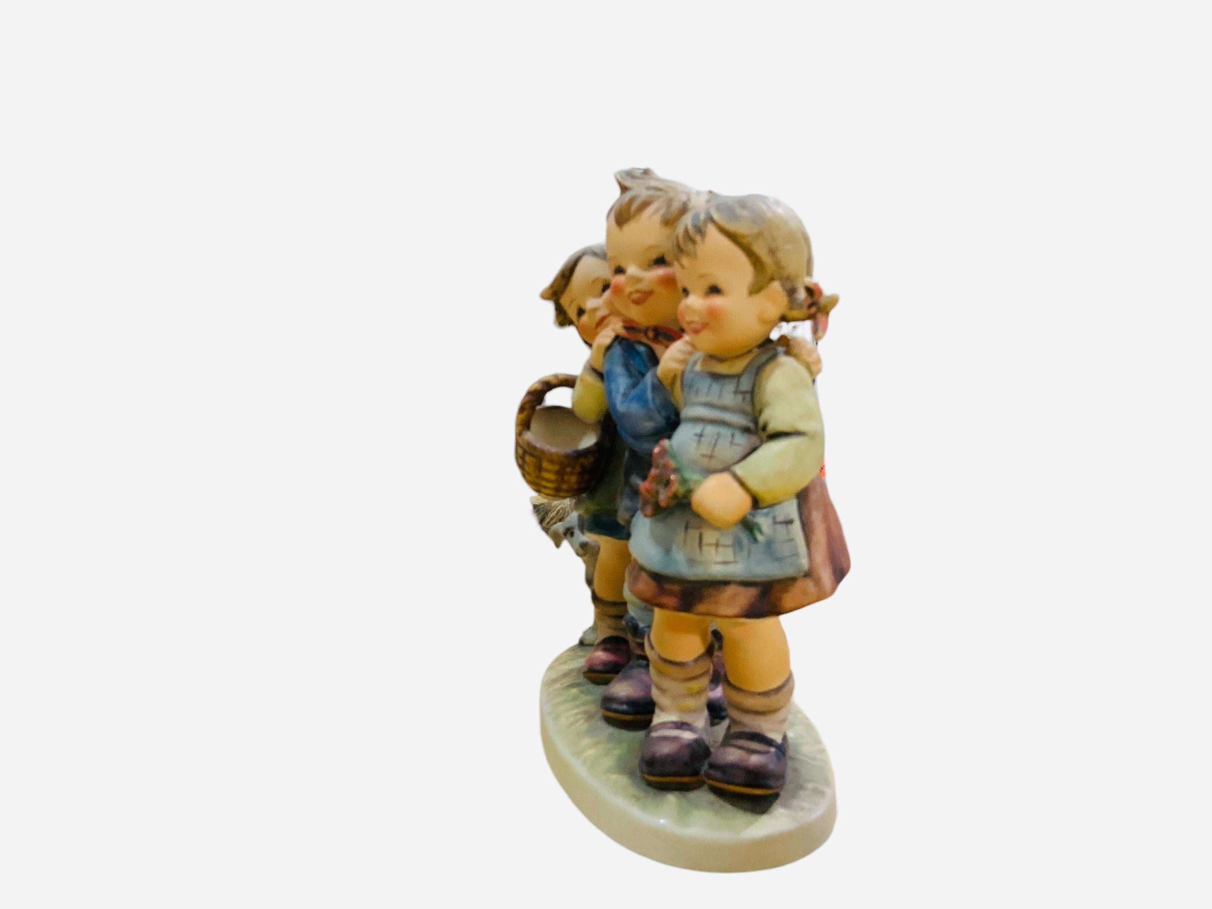 This is a Hummel porcelain group figurines of two girls and a boy. It’s named “Follow the Leader”. Its mark is TMK5 (1970’s). The inscription M.I. Hummel is in the back of the figurine. The trademark of Goebel company is below the base with the #369