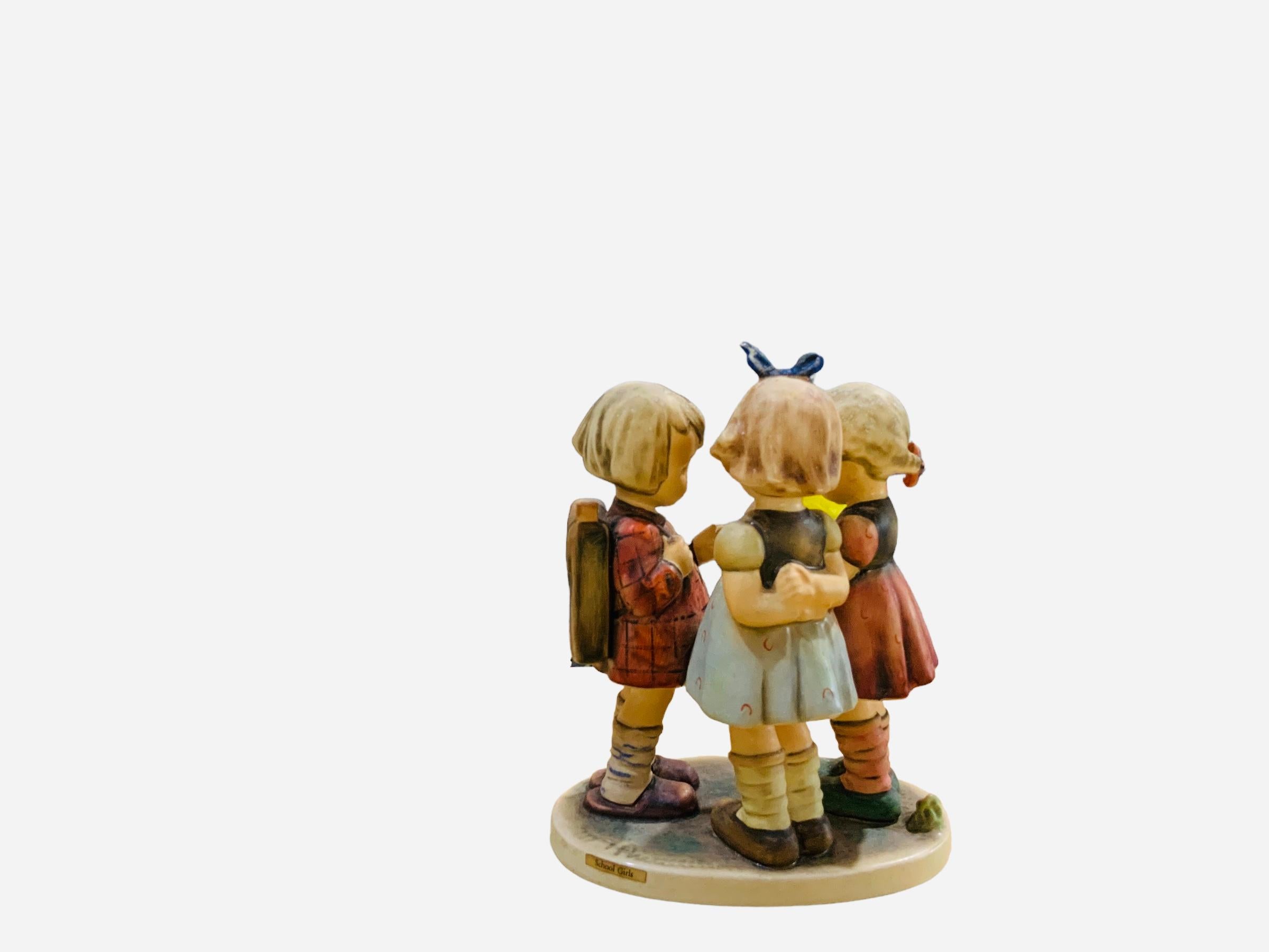 This is a Hummel porcelain group figurines of three girls. It’s named “School Girls”. Its mark is TMK5 (1970’s). The inscription M.I. Hummel is in the back of the figurine. The trademark of Goebel company is below the base.