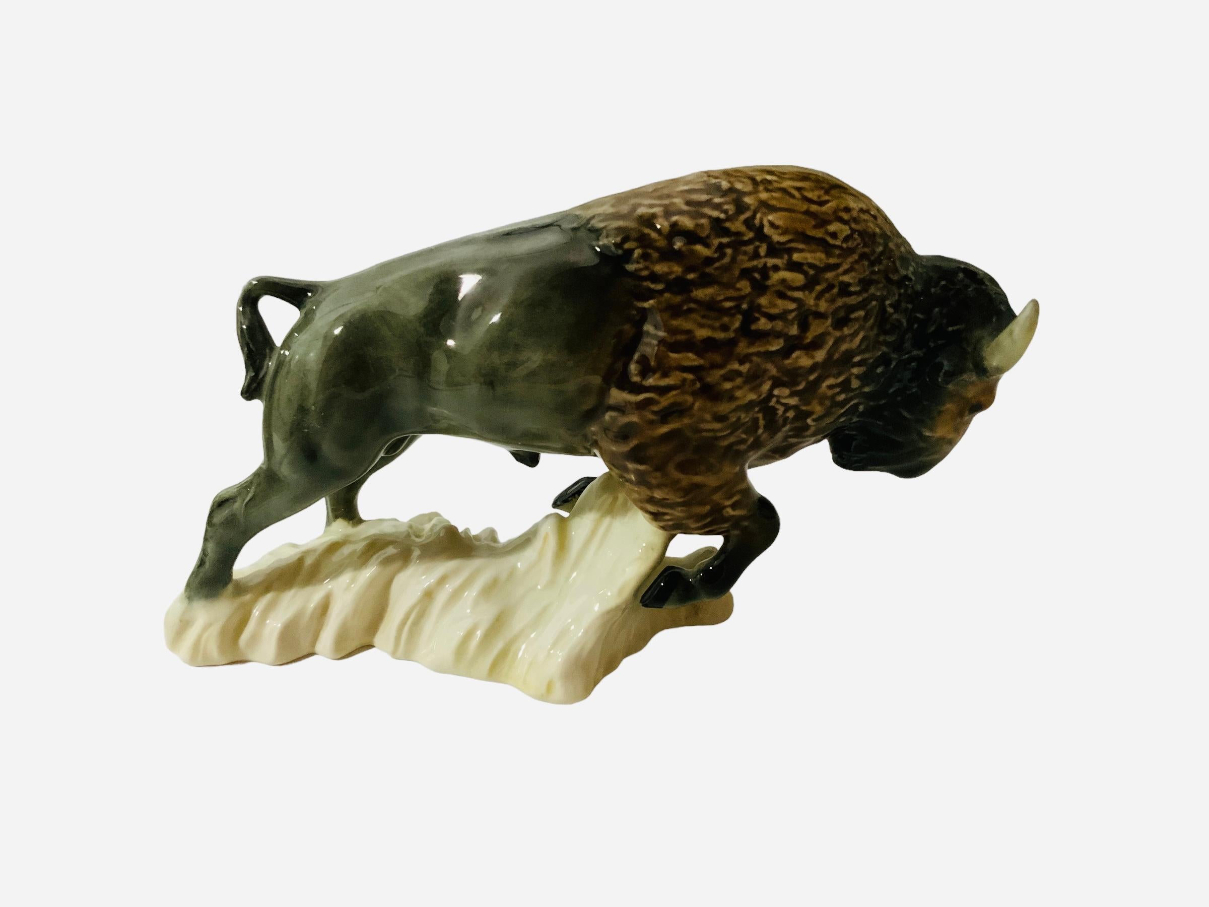 This is a Goeble porcelain figurine of a buffalo. It depicts a very well done hand painted brave and strong buffalo. He is plowing forward while it’s legs are lifting up soil. The American buffalo symbolizes abundance and manifestation. The Goeble