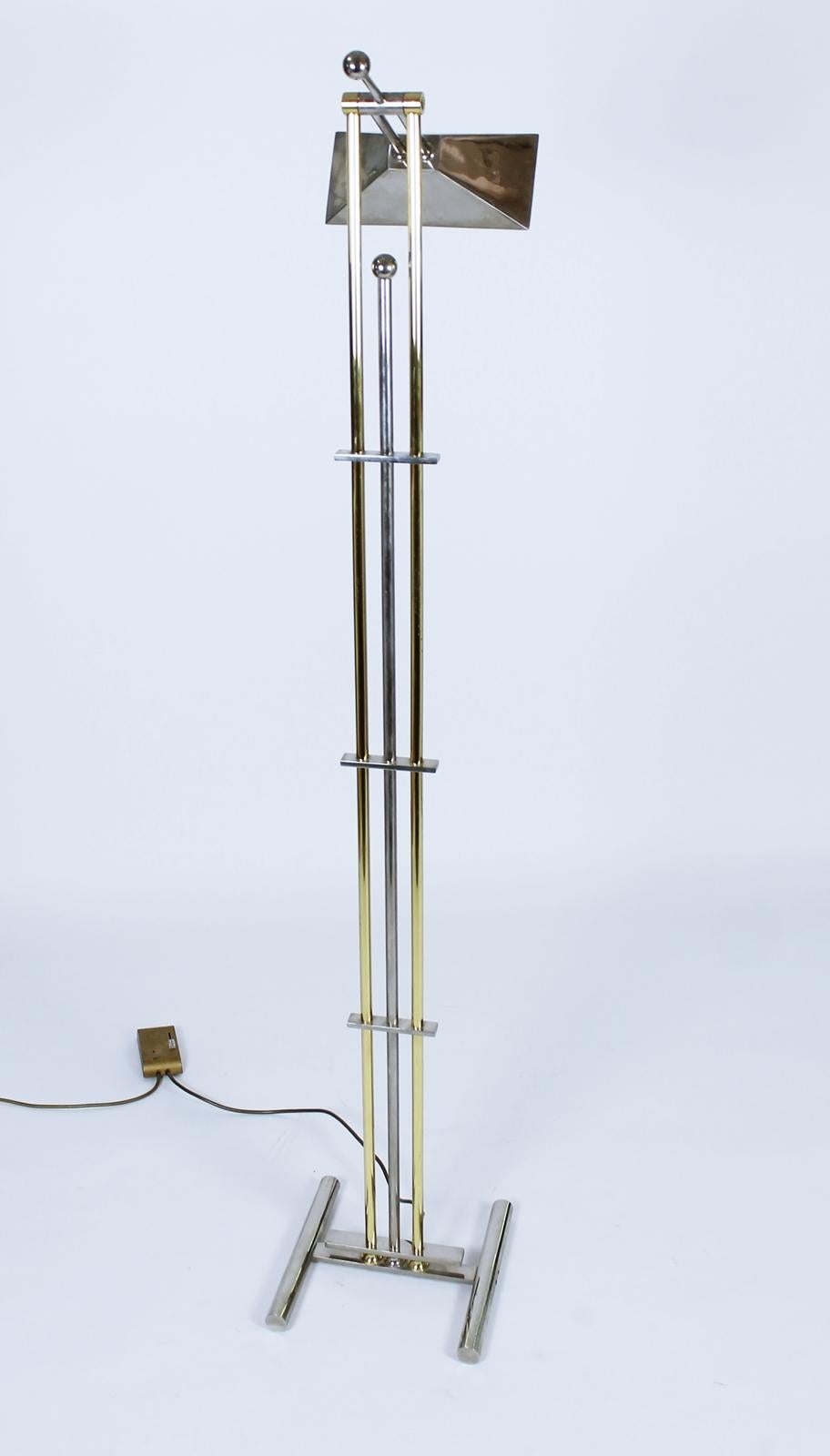 Unique floor lamp designed by Goetz, circa 1970.
 Signed.
 Features a polished chrome adjustable shade with heavy base from chrome and brass rods. 
The on/off switch is a 0-100% dimmer, located on the power cord.