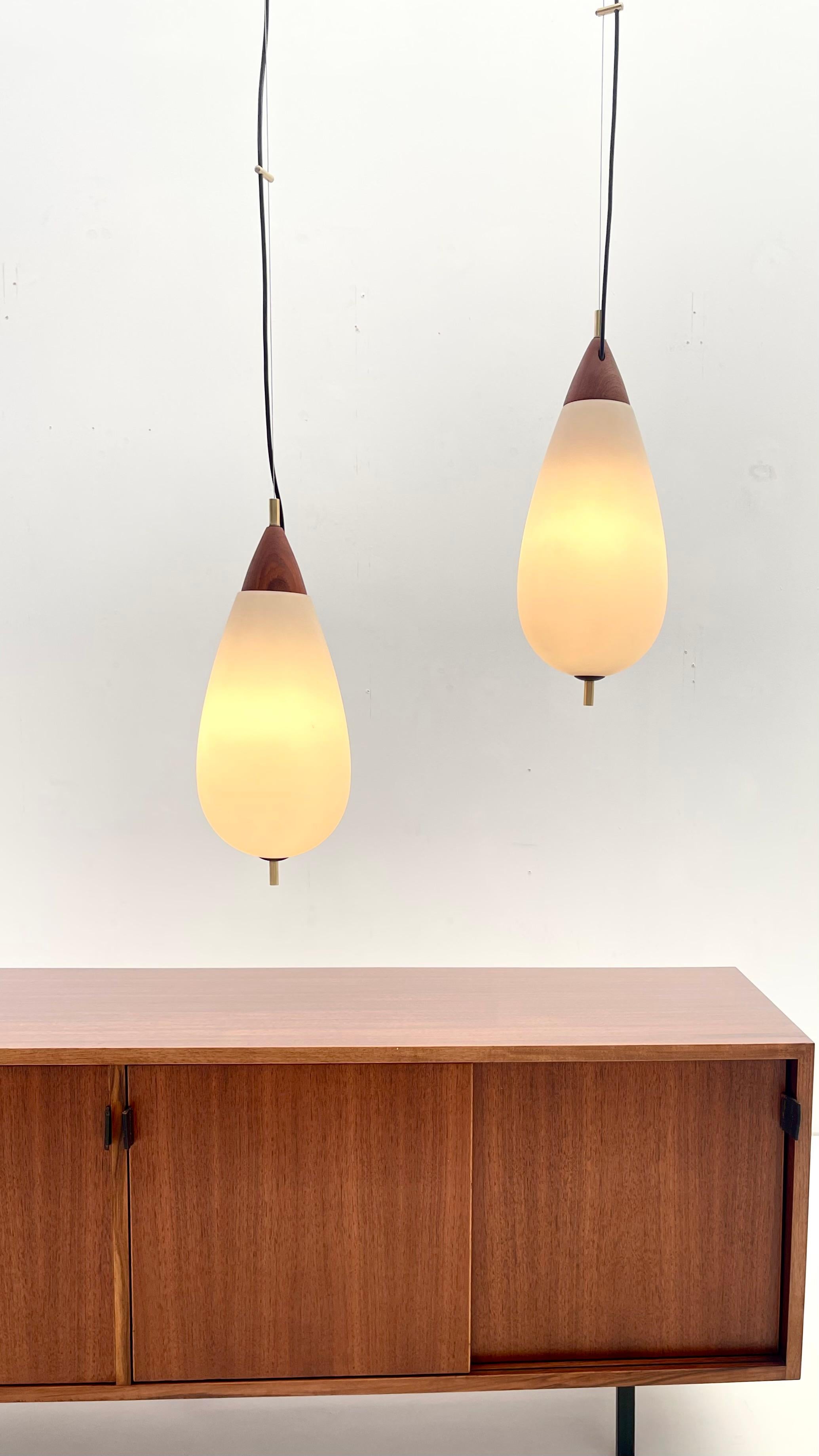 Teardrop pendant lights for Temde Leuchten by Goffredo Reggiani, with opalescent glass that diffuses a soft light.

Goffredo Reggiani (1929 - ) founded the Reggiani Illuminazione company in Italy in the early 1950s. He began by designing decorative