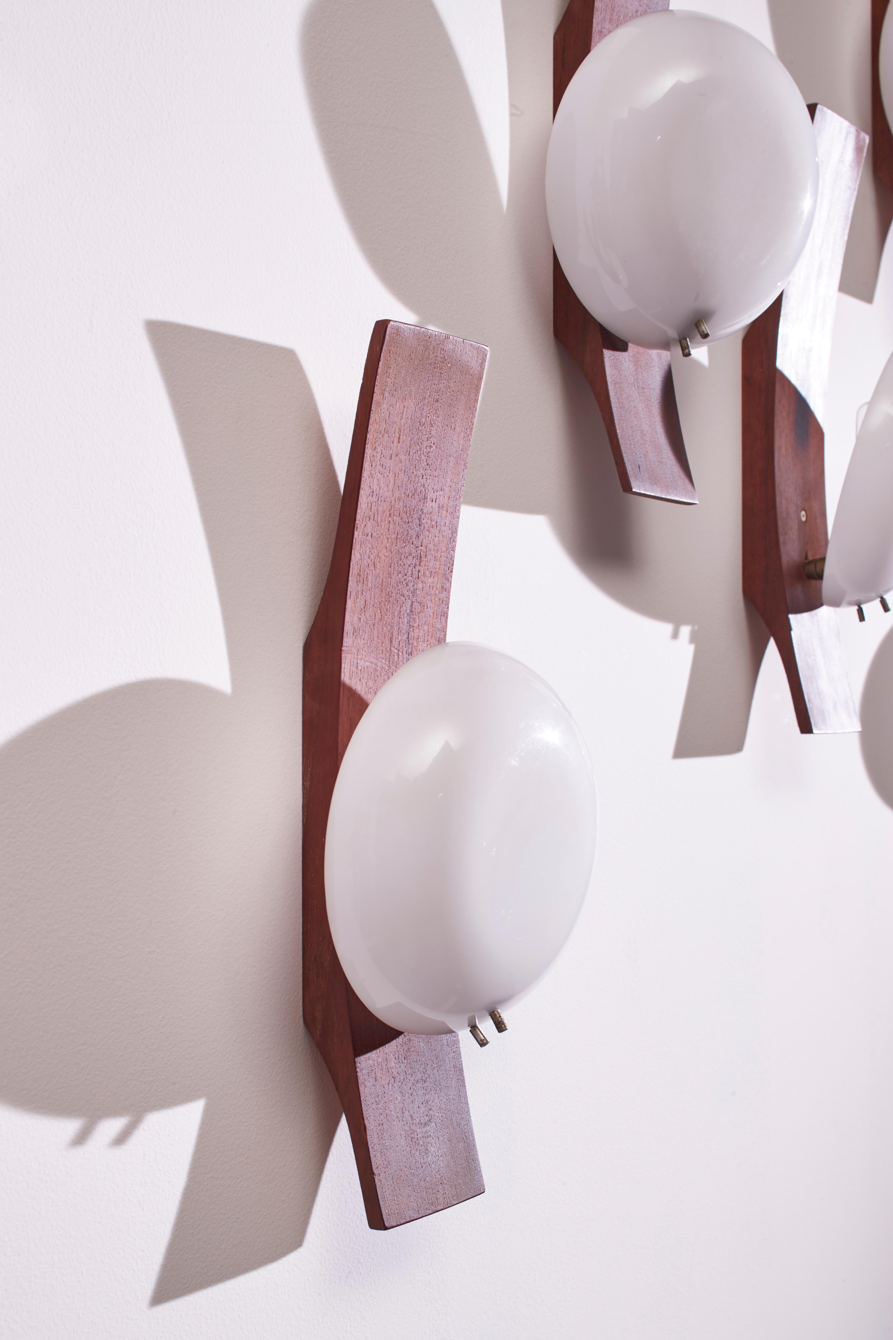 Plastic Goffredo Reggiani set of five teak and perspex wall lights, Italy, 1960s