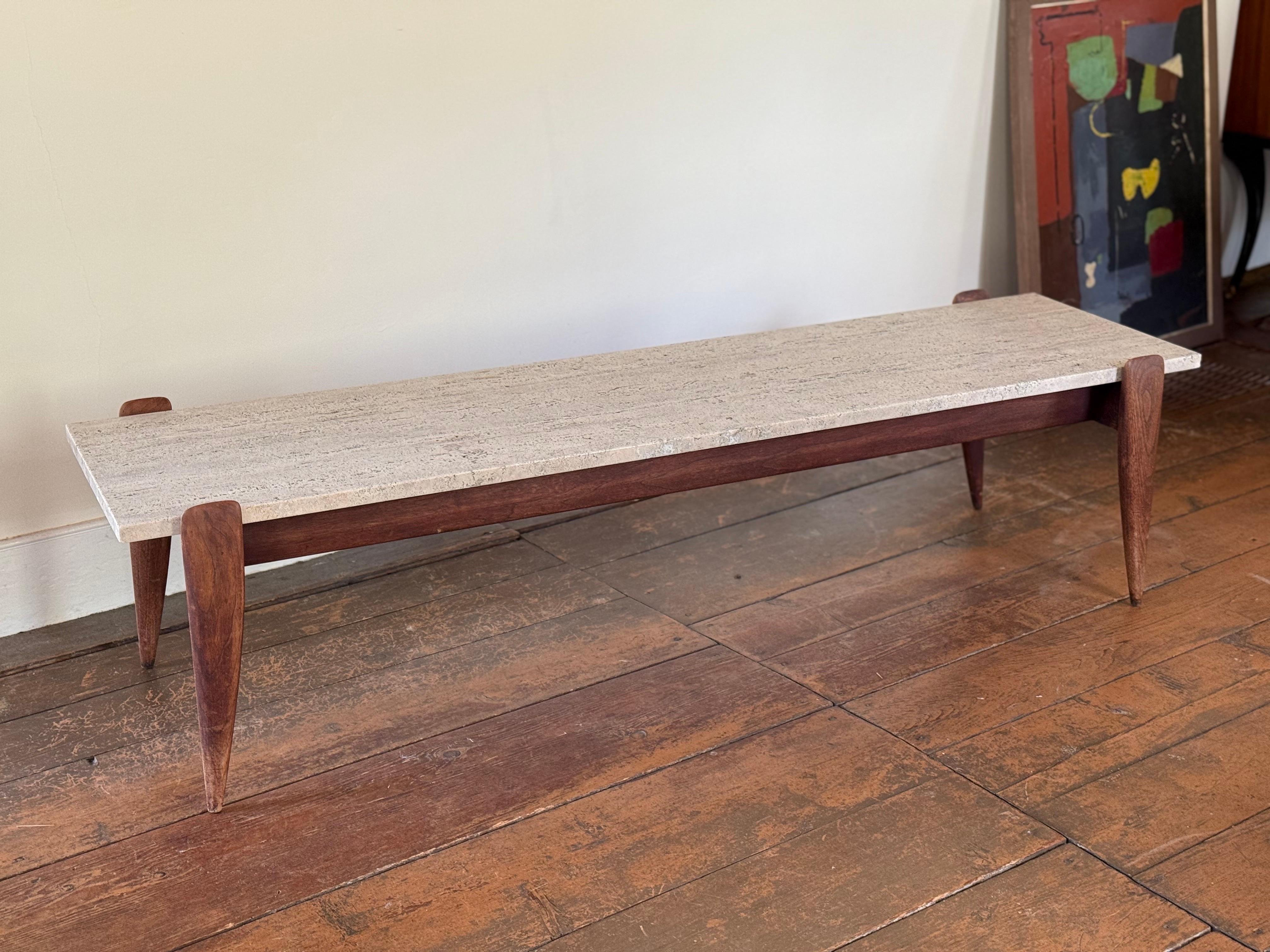 Gio Ponti for M. Singer & Sons
Travertine top and sculpted walnut base
Retains original label and beautiful natural patina. 
We offer nationwide shipping solutions message us for a quote.  