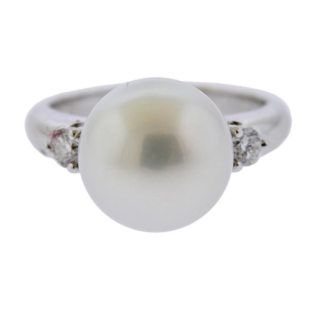 18 white gold cocktail ring, set with 12.2mm South Sea pearl and two diamonds (approx. 0.24ctw). Ring size 6.5. Marked 750. Weight 8.3 grams.