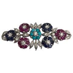Gold 18 Karat Brooch Witt White Diamonds, Blue Sapphire, Ruby and Turquoise